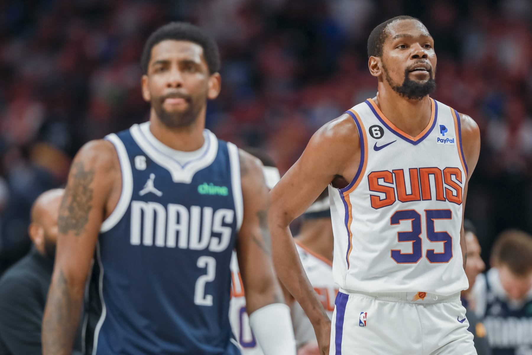 Dallas Mavericks guard Kyrie Irving (2) and Phoenix Suns forward Kevin Durant (35) walk down the court during the second half of an NBA basketball game, Sunday, March 5, 2023, in Dallas. (AP Photo/Gareth Patterson)
