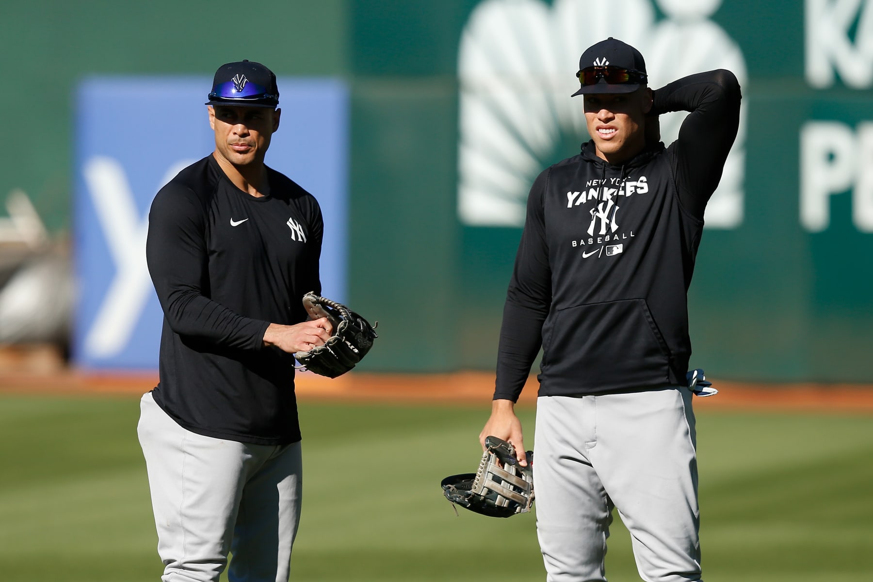 OAKLAND, CALIFORNIA - AUGUST 25: Giancarlo Stanton #27 and Aaron Judge #99 of the New York Yankees look on before the game against the Oakland Athletics at RingCentral Coliseum on August 25, 2022 in Oakland, California. (Photo by Lachlan Cunningham/Getty Images)