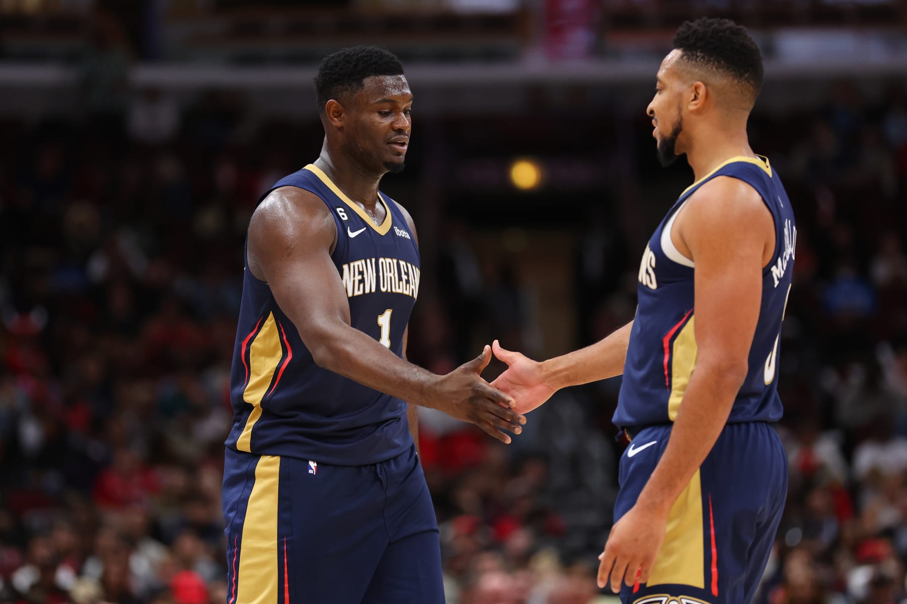 CHICAGO, ILLINOIS - OCTOBER 04: Zion Williamson #1 of the New Orleans Pelicans high fives CJ McCollum #3 against the Chicago Bulls during the second half of a preseason game at the United Center on October 04, 2022 in Chicago, Illinois.NOTE TO USER: User expressly acknowledges and agrees that, by downloading and or using this photograph, User is consenting to the terms and conditions of the Getty Images License Agreement. (Photo by Michael Reaves/Getty Images)