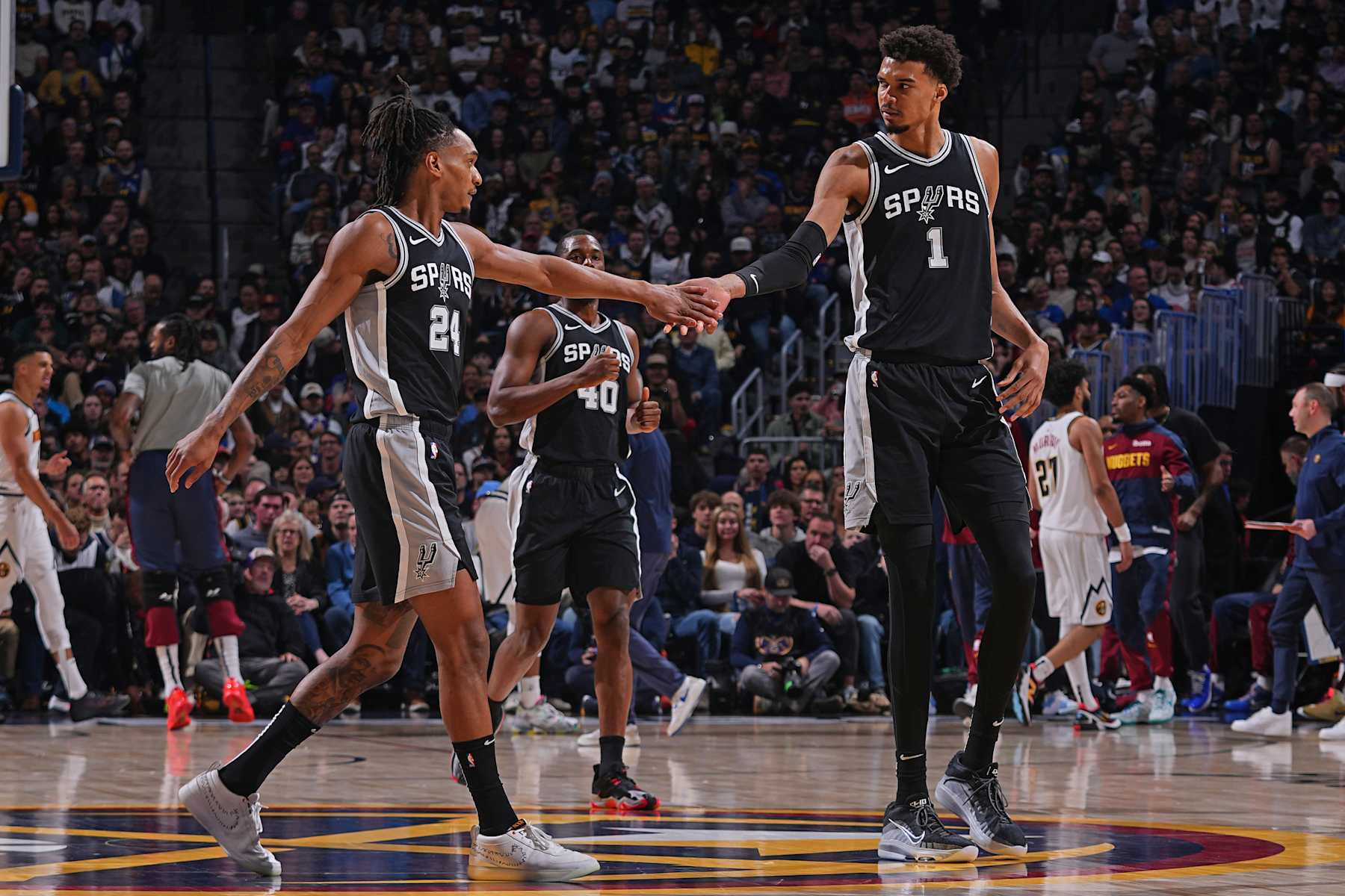 DENVER, CO - JANUARY 3: Devin Vassell #24 of the San Antonio Spurs high fives Victor Wembanyama #1 of the San Antonio Spurs during the game against the Denver Nuggets on January 3, 2025 at Ball Arena in Denver, Colorado. NOTE TO USER: User expressly acknowledges and agrees that, by downloading and/or using this Photograph, user is consenting to the terms and conditions of the Getty Images License Agreement. Mandatory Copyright Notice: Copyright 2025 NBAE (Photo by Bart Young/NBAE via Getty Images)