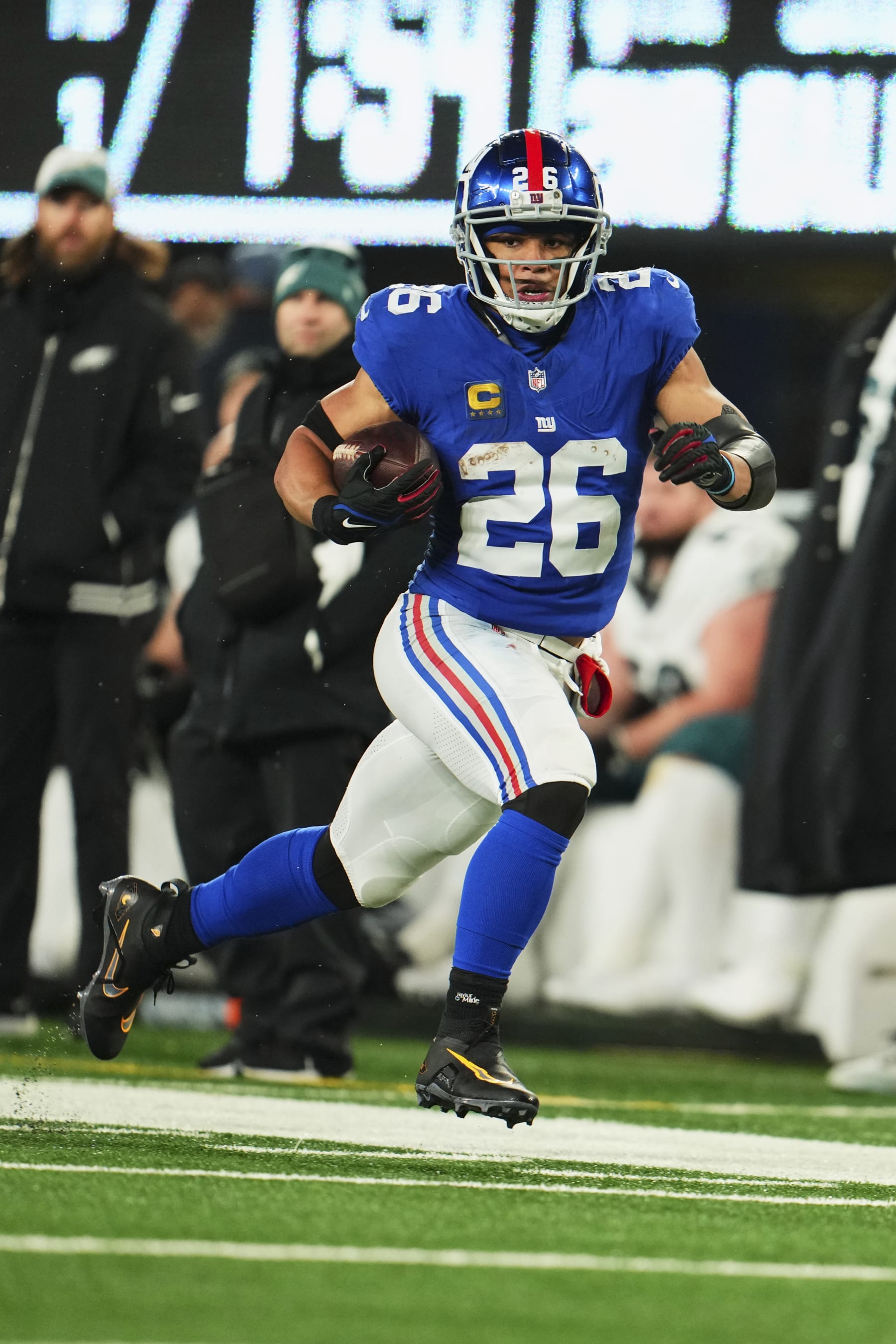 EAST RUTHERFORD, NJ - JANUARY 07: Saquon Barkley #26 of the New York Giants runs with the ball against the Philadelphia Eagles during the first half at MetLife Stadium on January 7, 2024 in East Rutherford, New Jersey. (Photo by Cooper Neill/Getty Images)