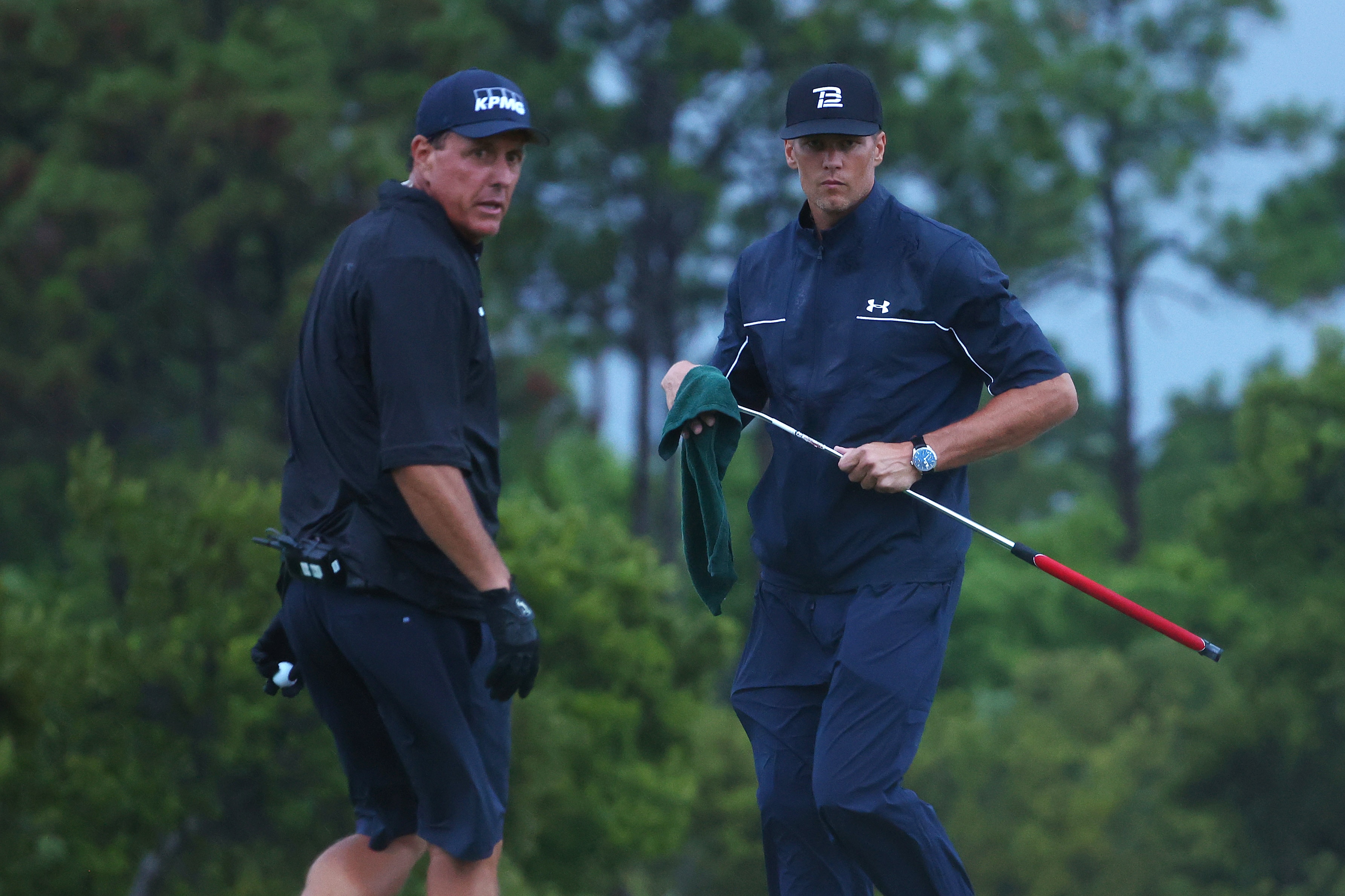 HOBE SOUND, FLORIDA - MAY 24:  Phil Mickelson reads a putt for NFL player Tom Brady of the Tampa Bay Buccaneers looks on the 17th green during The Match: Champions For Charity at Medalist Golf Club on May 24, 2020 in Hobe Sound, Florida. (Photo by Mike Ehrmann/Getty Images for The Match)