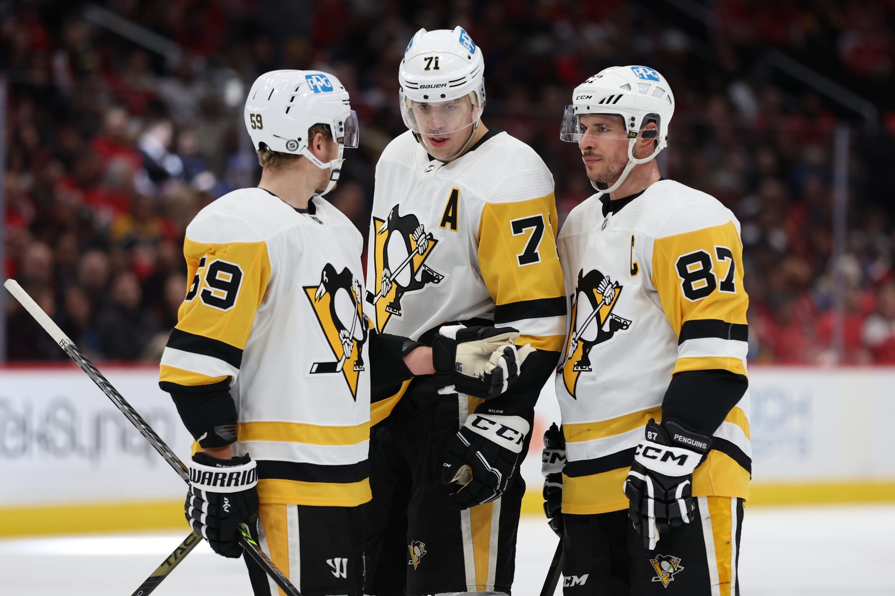 WASHINGTON, DC - JANUARY 26: Sidney Crosby #87 of the Pittsburgh Penguins talks with teammates Evgeni Malkin #71 and Jake Guentzel #59 against the Washington Capitals during the first period at Capital One Arena on January 26, 2023 in Washington, DC. (Photo by Patrick Smith/Getty Images)