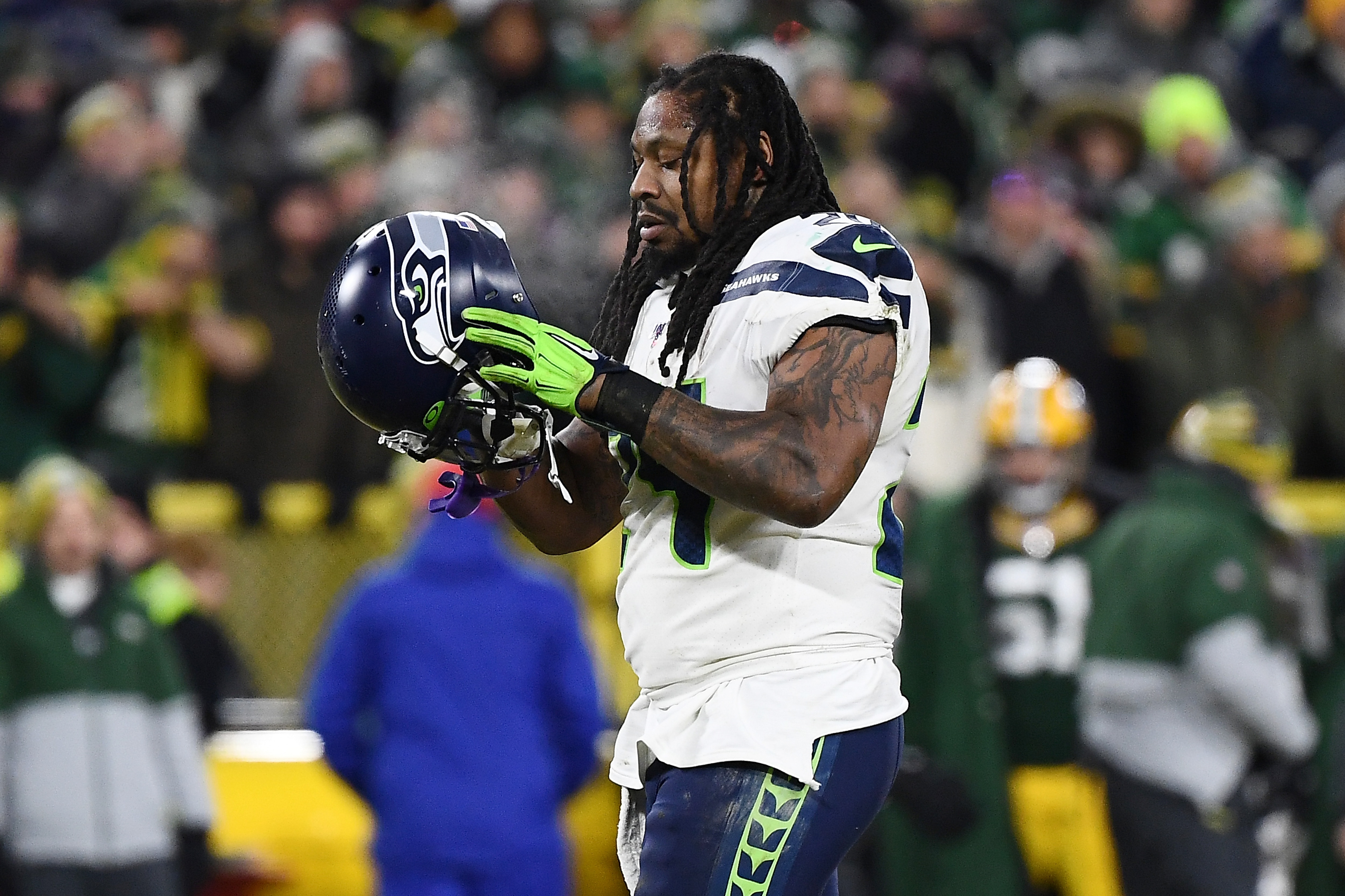 GREEN BAY, WISCONSIN - JANUARY 12:  Marshawn Lynch #24 of the Seattle Seahawks walks to the huddle during the NFC Divisional Playoff game against the Green Bay Packers at Lambeau Field on January 12, 2020 in Green Bay, Wisconsin. (Photo by Stacy Revere/Getty Images)