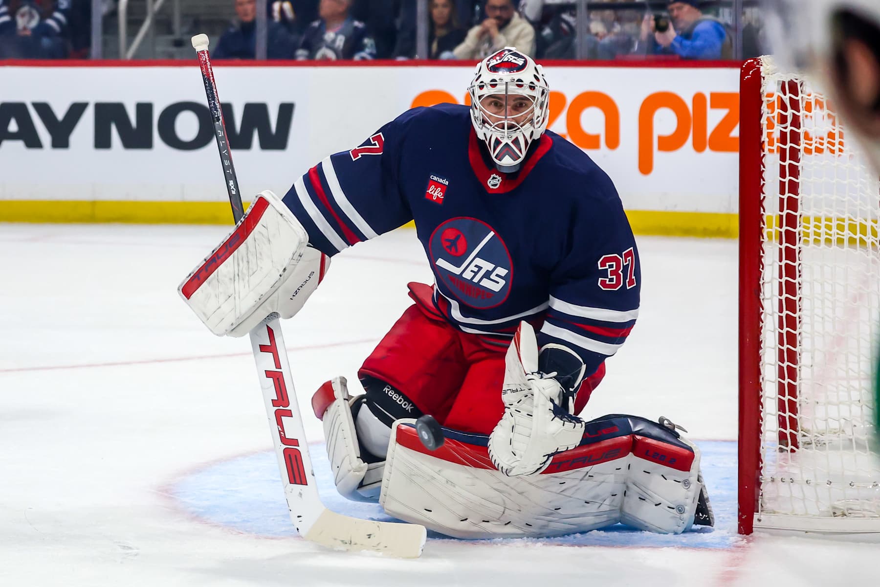 WINNIPEG, CANADA - NOVEMBER 9: Goaltender Connor Hellebuyck #37 of the Winnipeg Jets keeps an eye on the play during first period action against the Dallas Stars at the Canada Life Centre on November 9, 2024 in Winnipeg, Manitoba, Canada. (Photo by Jonathan Kozub/NHLI via Getty Images)