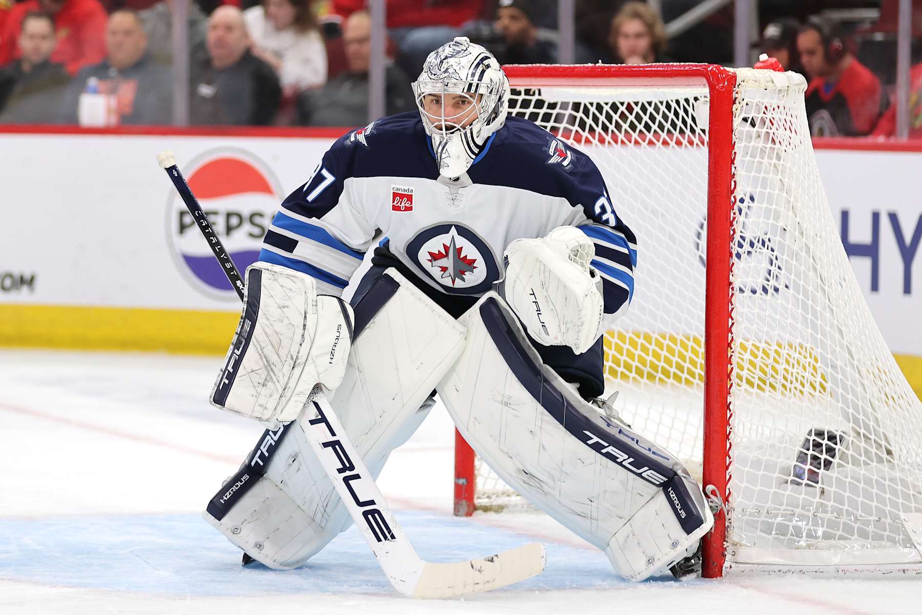 CHICAGO, ILLINOIS - DECEMBER 07: Connor Hellebuyck #37 of the Winnipeg Jets tends the net against the Chicago Blackhawks during the second period at the United Center on December 07, 2024 in Chicago, Illinois. (Photo by Michael Reaves/Getty Images)