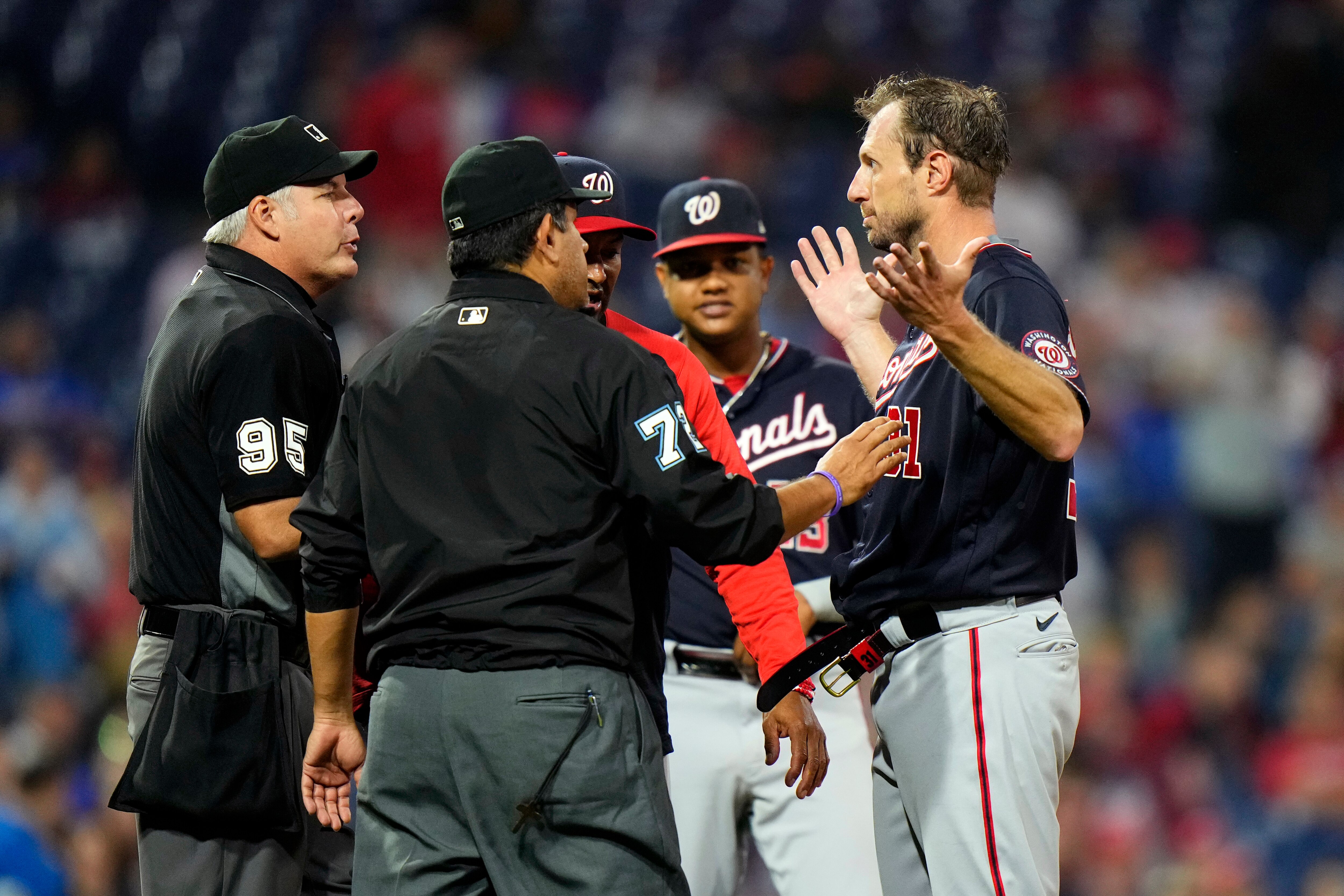 Washington Nationals pitcher Max Scherzer, right, is checked for foreign substances during the middle of the fourth inning of a baseball game against the Philadelphia Phillies, Tuesday, June 22, 2021, in Philadelphia. (AP Photo/Matt Slocum)