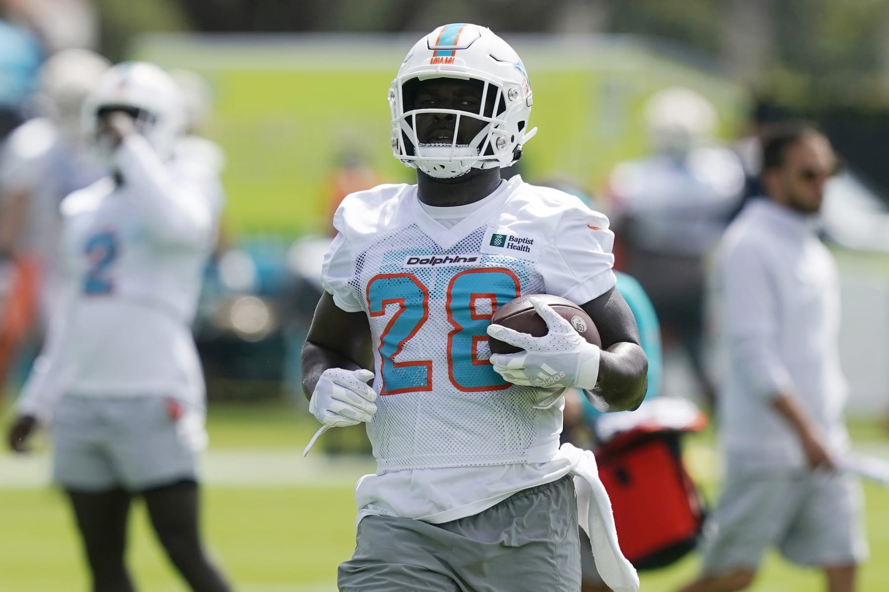 Miami Dolphins running back Sony Michel takes part in drills at the NFL football team's practice facility, Saturday, July 30, 2022, in Miami Gardens, Fla. (AP Photo/Marta Lavandier)