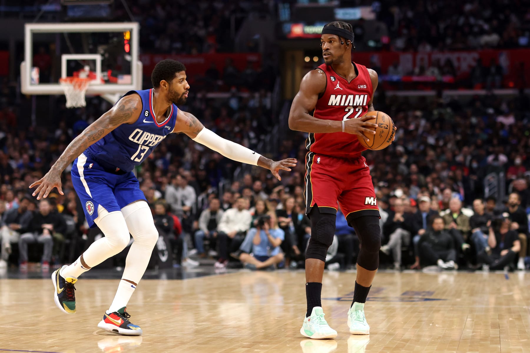 LOS ANGELES, CALIFORNIA - JANUARY 02: Jimmy Butler #22 of the Miami Heat handles the ball against Paul George #13 of the Los Angeles Clippers during the third quarter at Crypto.com Arena on January 02, 2023 in Los Angeles, California. NOTE TO USER: User expressly acknowledges and agrees that, by downloading and or using this photograph, User is consenting to the terms and conditions of the Getty Images License Agreement. (Photo by Katelyn Mulcahy/Getty Images)