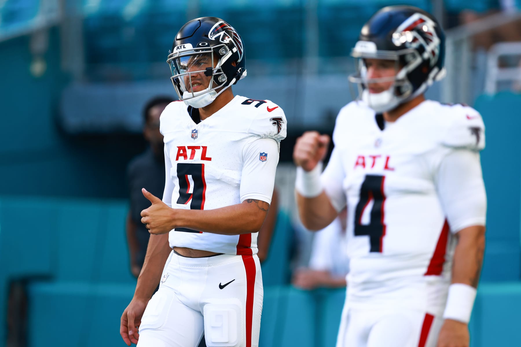 MIAMI GARDENS, FLORIDA - AUGUST 11: Desmond Ridder #9 and Taylor Heinicke #4 of the Atlanta Falcons warms up prior to playing the Miami Dolphins in a preseason game at Hard Rock Stadium on August 11, 2023 in Miami Gardens, Florida. (Photo by Megan Briggs/Getty Images)
