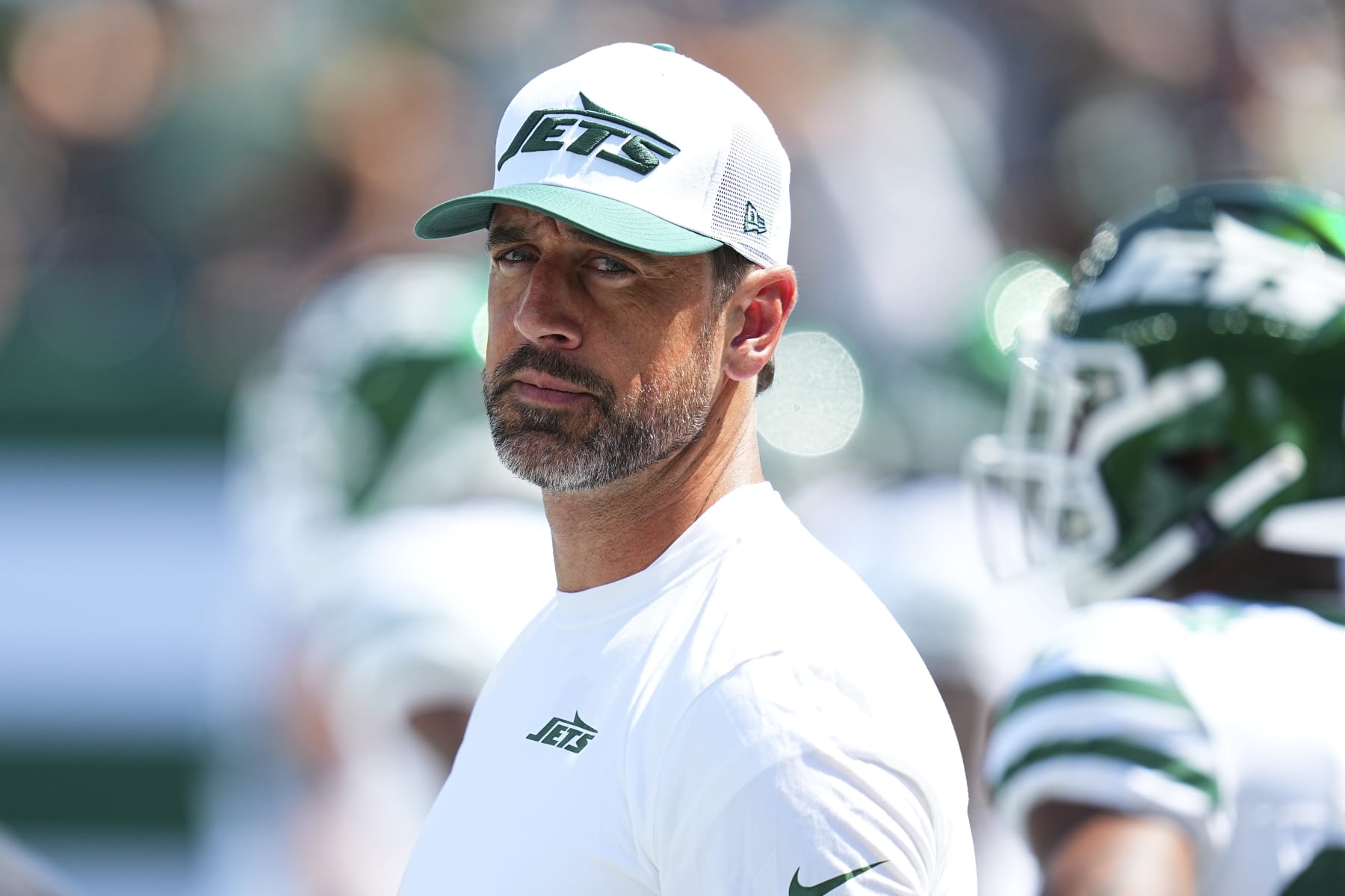 EAST RUTHERFORD, NEW JERSEY - AUGUST 10: Aaron Rodgers #8 of the New York Jets looks on against the Washington Commanders during the preseason game at MetLife Stadium on August 10, 2024 in East Rutherford, New Jersey. The Jets defeated the Commanders 20-17. (Photo by Mitchell Leff/Getty Images)
