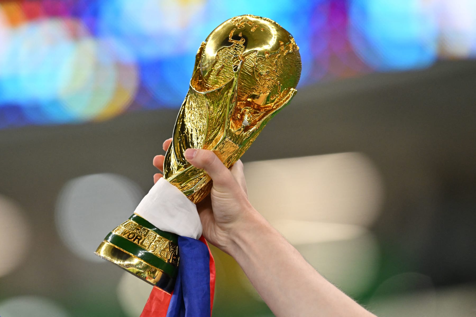 TOPSHOT - A France supporter carries a replica of the trophy ahead of the Qatar 2022 World Cup round of 16 football match between France and Poland at the Al-Thumama Stadium in Doha on December 4, 2022. (Photo by Glyn KIRK / AFP) (Photo by GLYN KIRK/AFP via Getty Images)