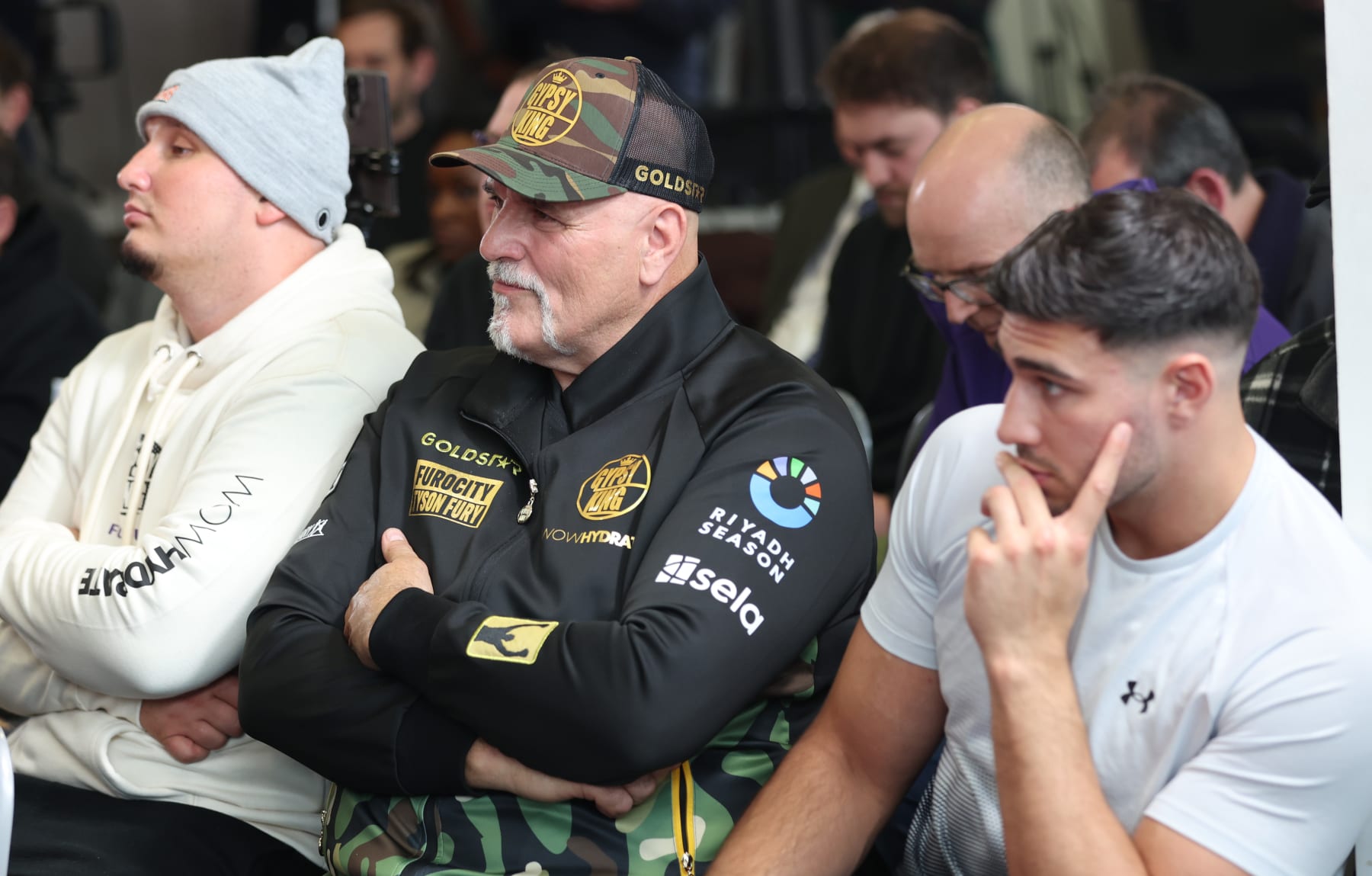 MORECAMBE, ENGLAND - APRIL 10: John Fury and Tommy Fury watch on during the Tyson Fury press conference ahead of the IBF, IBO, WBA, WBO and WBC Undisputed World Heavyweight title fight against Oleksandr Usyk on the 'Ring of Fire' card  at Mazuma Stadium on April 10, 2024 in Morecambe, England.  (Photo by Nathan Stirk/Getty Images)