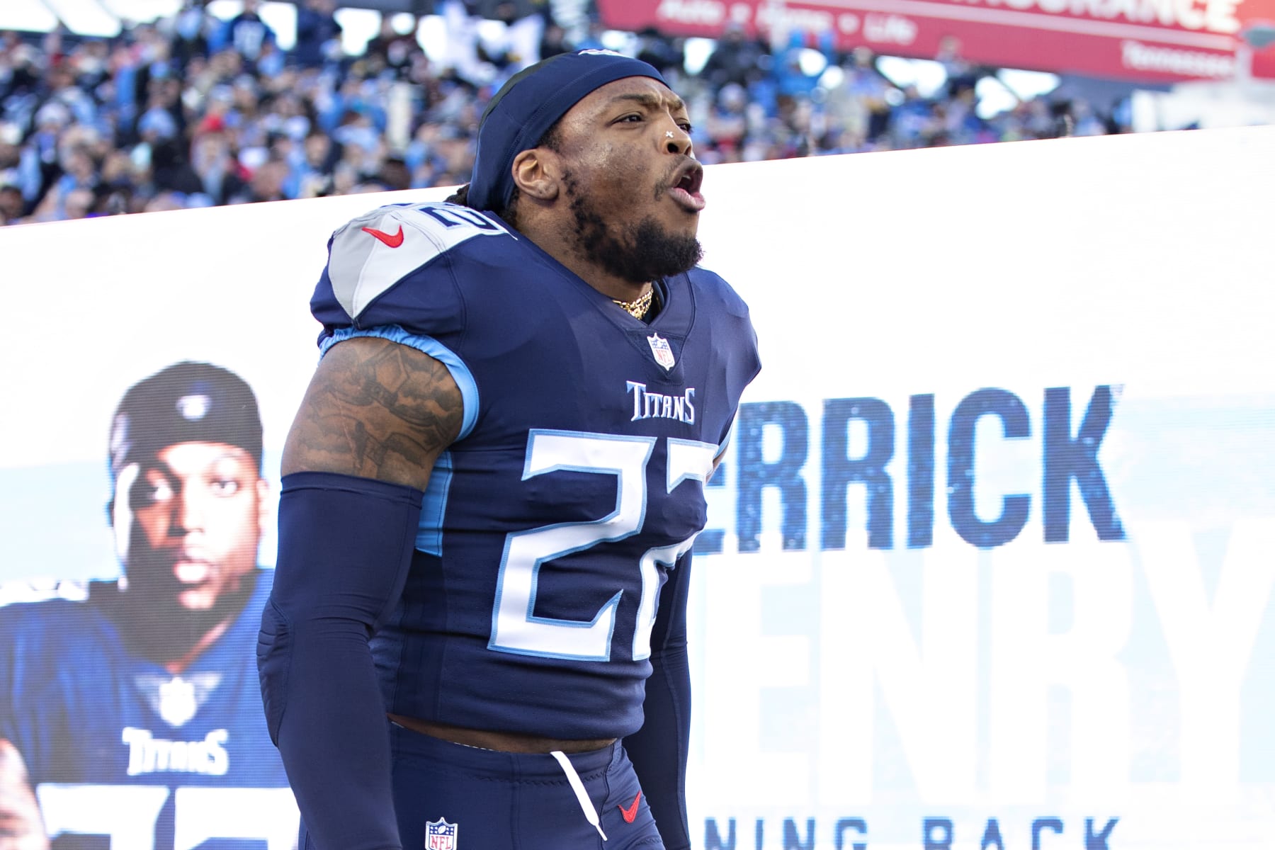 NASHVILLE, TENNESSEE - JANUARY 22: Derrick Henry #22 of the Tennessee Titans runs onto the field during introductions before a game against the Cincinnati Bengals in the AFC Divisional Playoff game at Nissan Stadium on January 22, 2022 in Nashville, Tennessee. The Bengals defeated the Titans 19-16.  (Photo by Wesley Hitt/Getty Images)
