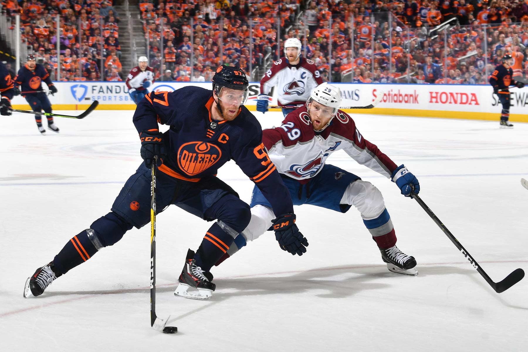 EDMONTON, AB - JUNE 6: Connor McDavid #97 of the Edmonton Oilers skates with the puck while being pursued by Nathan MacKinnon #29 of the Colorado Avalanche Game Four of the Western Conference Finals of the 2022 Stanley Cup Playoffs on June 6, 2022 at Rogers Place in Edmonton, Alberta, Canada. (Photo by Andy Devlin/NHLI via Getty Images)