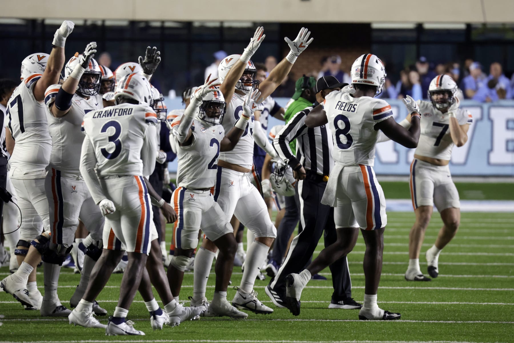 Virginia players celebrate an upset win over North Carolina as time runs out during the second half of an NCAA college football game, Saturday, Oct. 21, 2023, in Chapel Hill, N.C. Virginia linebacker James Jackson (7), right, intercepted a pass the seal the win. (AP Photo/Chris Seward) Virginia players celebrate an upset win over North Carolina as time runs out during the second half of an NCAA college football game, Saturday, Oct. 21, 2023, in Chapel Hill, N.C. Virginia linebacker James Jackson (7), right, intercepted a pass the seal the win. (AP Photo/Chris Seward)