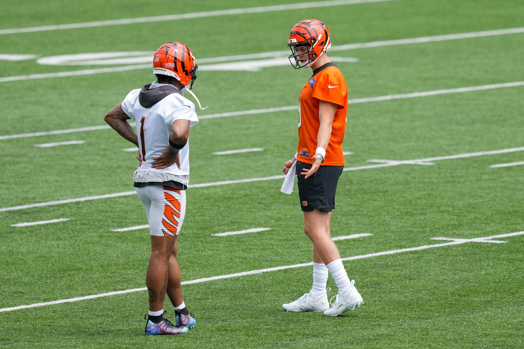 CINCINNATI, OHIO - JUNE 13: Ja'Marr Chase #1 and Joe Burrow #9 of the Cincinnati Bengals meet during an offseason workout on June 13, 2023 in Cincinnati, Ohio. (Photo by Dylan Buell/Getty Images)