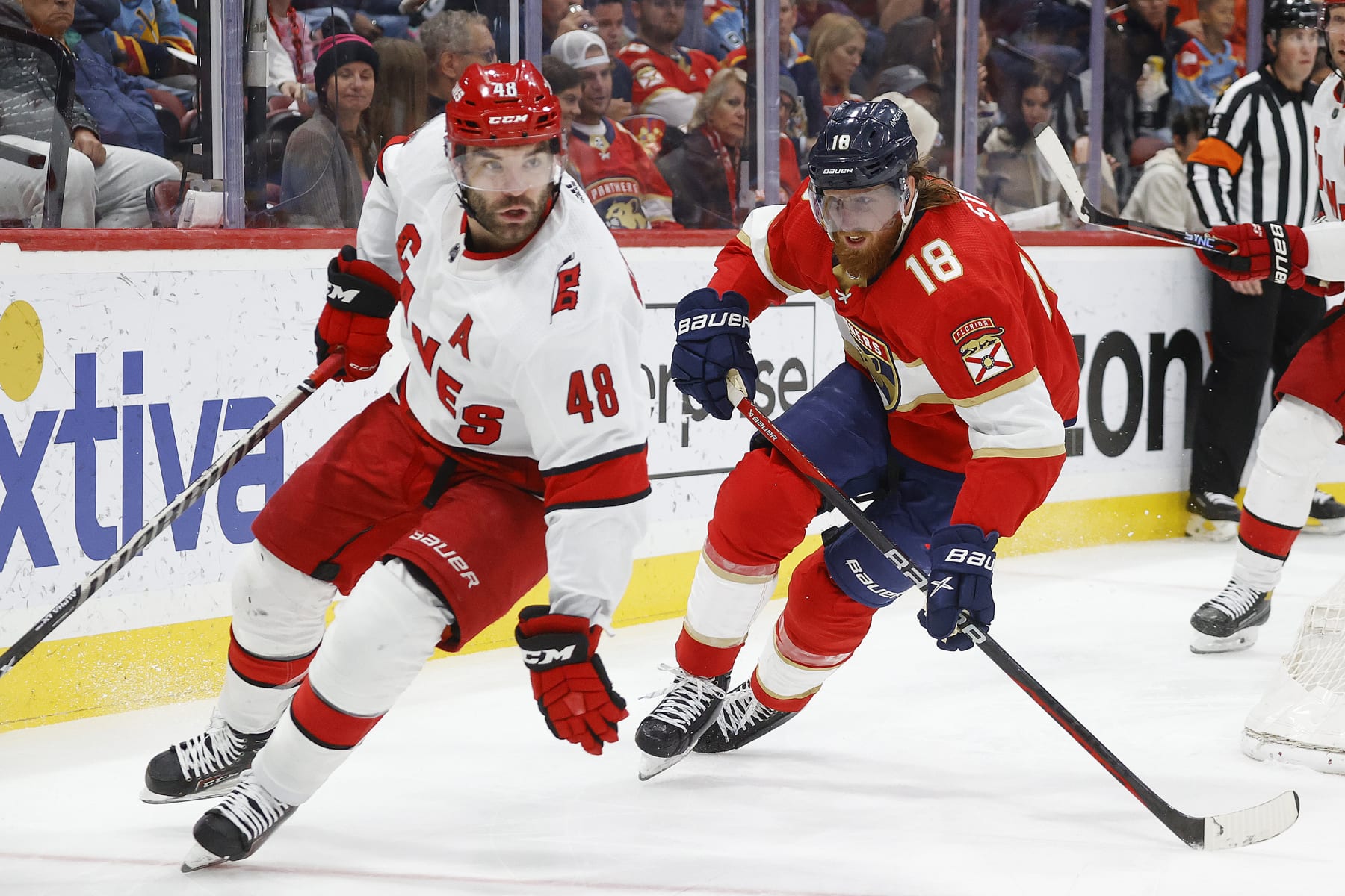 SUNRISE, FL - APRIL 13: Marc Staal #18 of the Florida Panthers pursues Jordan Martinook #48 of the Carolina Hurricanes as he skates with the puck during second period action at the FLA Live Arena on April 13, 2023 in Sunrise, Florida. (Photo by Joel Auerbach/Getty Images)