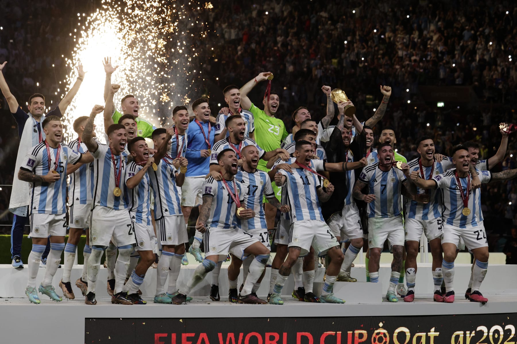 LUSAIL CITY, QATAR - DECEMBER 18: Lionel Messi of Argentina and team lift trophy after winning the FIFA World Cup Qatar 2022 Final match between Argentina and France at Lusail Stadium on December 18, 2022 in Lusail City, Qatar. (Photo by Richard Sellers/Getty Images)