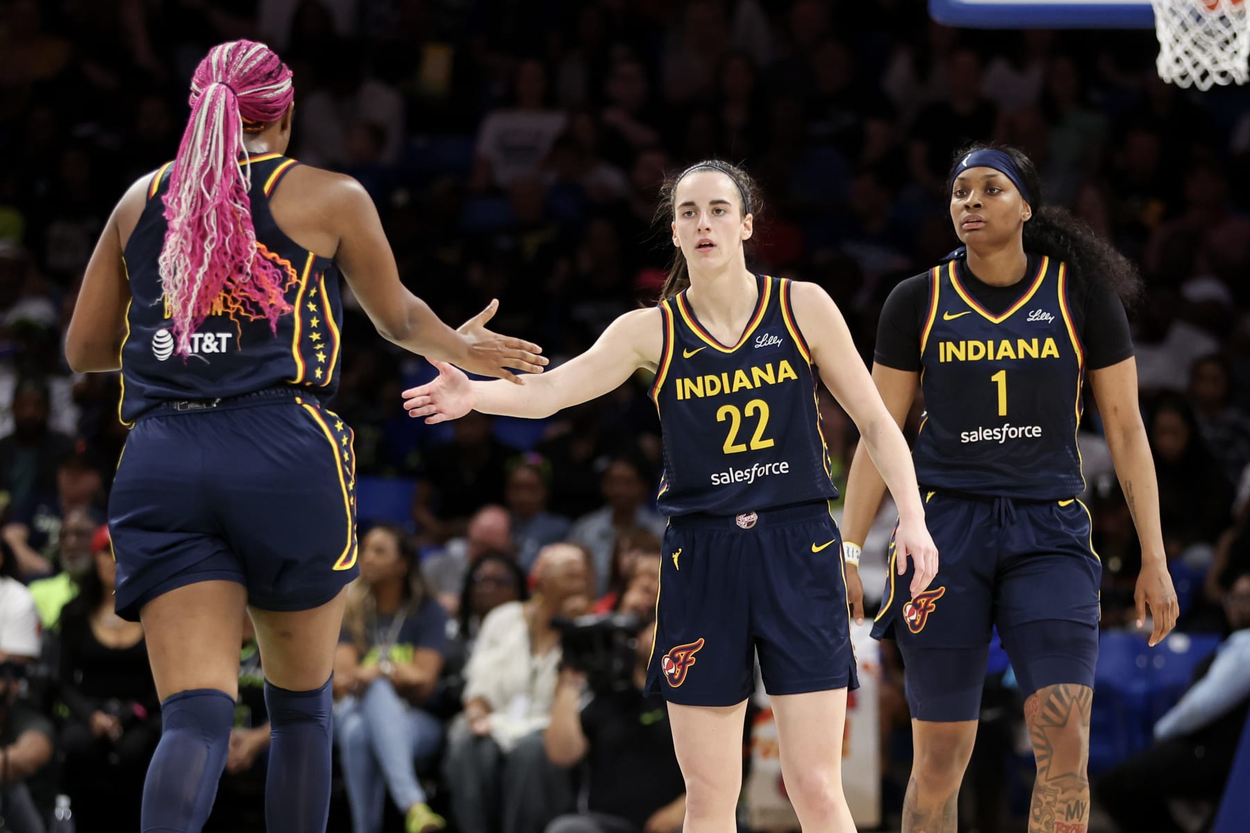 ARLINGTON, TEXAS - MAY 03: Caitlin Clark #22 of the Indiana Fever high-fives Aliyah Boston #7 after a basket against the Dallas Wings during the second quarter in the preseason game at College Park Center on May 03, 2024 in Arlington, Texas.  (Photo by Gregory Shamus/Getty Images)