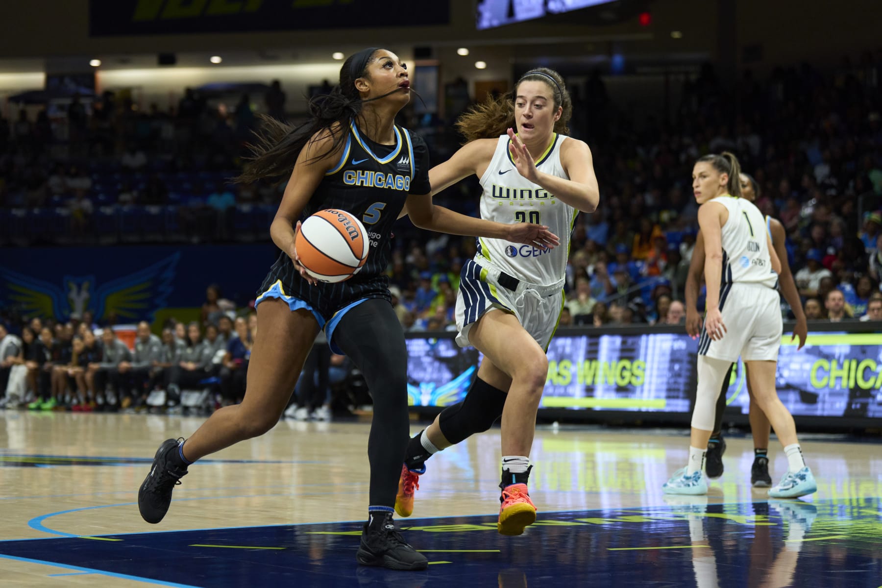 ARLINGTON, TEXAS - MAY 15: Angel Reese #5 of the Chicago Sky drives to the basket against the Dallas Wings in the first half at the College Park Center on May 15, 2024 in Arlington, Texas. NOTE TO USER: User expressly acknowledges and agrees that, by downloading and or using this photograph, User is consenting to the terms and conditions of the Getty Images License Agreement.  (Photo by Cooper Neill/Getty Images)