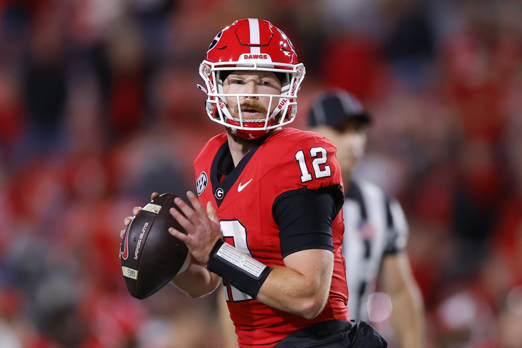 ATHENS, GEORGIA - OCTOBER 7: Brock Vandagriff #12 of the Georgia Bulldogs looks for a pass during the fourth quarter against the Kentucky Wildcats at Sanford Stadium on October 7, 2023 in Athens, Georgia. (Photo by Todd Kirkland/Getty Images)