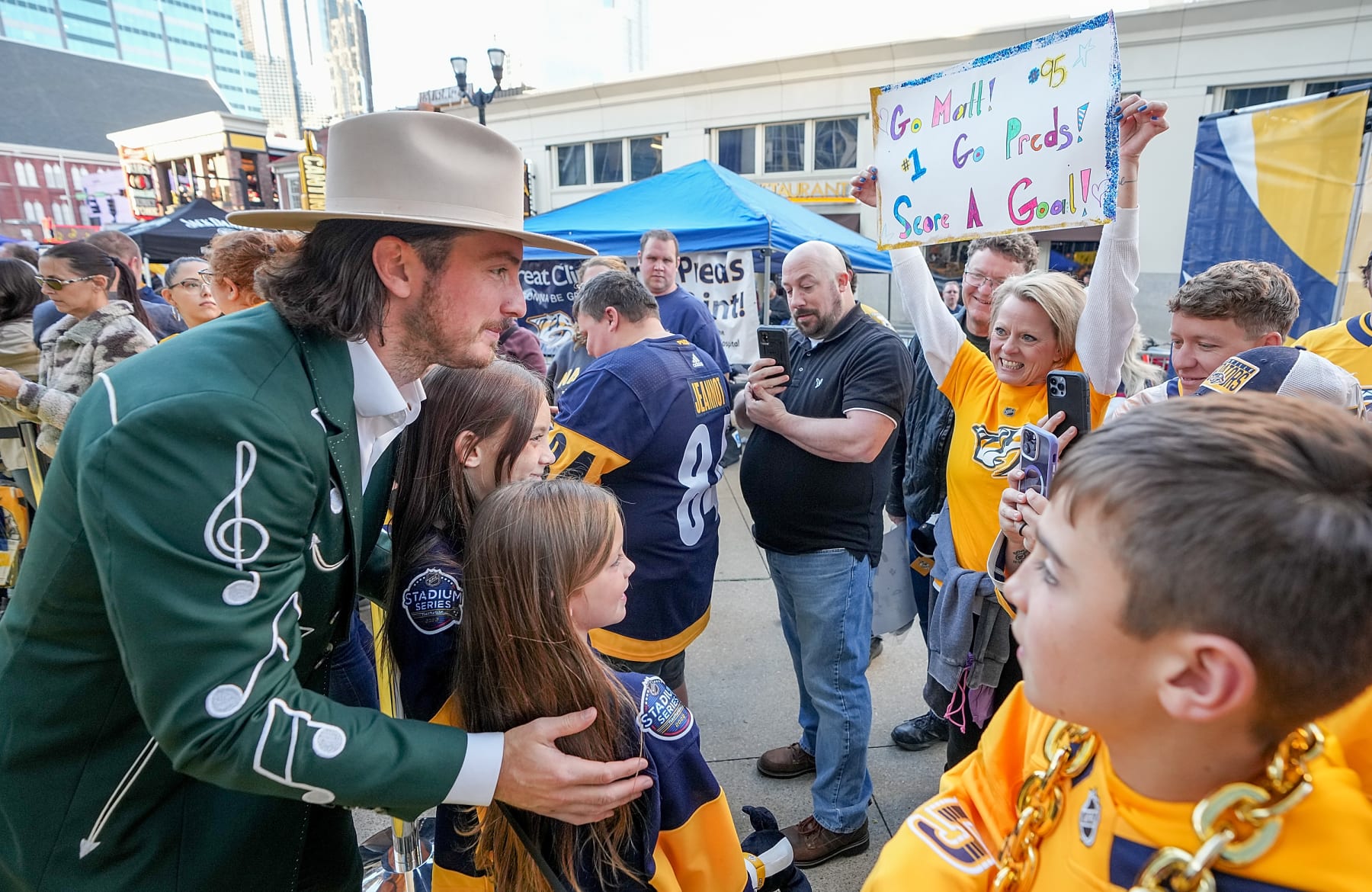 NASHVILLE, TENNESSEE - OCTOBER 13: Matt Duchene #95 of the Nashville Predators poses with fans on the Gold Walk prior to an NHL game against the Dallas Stars at Bridgestone Arena on October 13, 2022 in Nashville, Tennessee. (Photo by John Russell/NHLI via Getty Images)