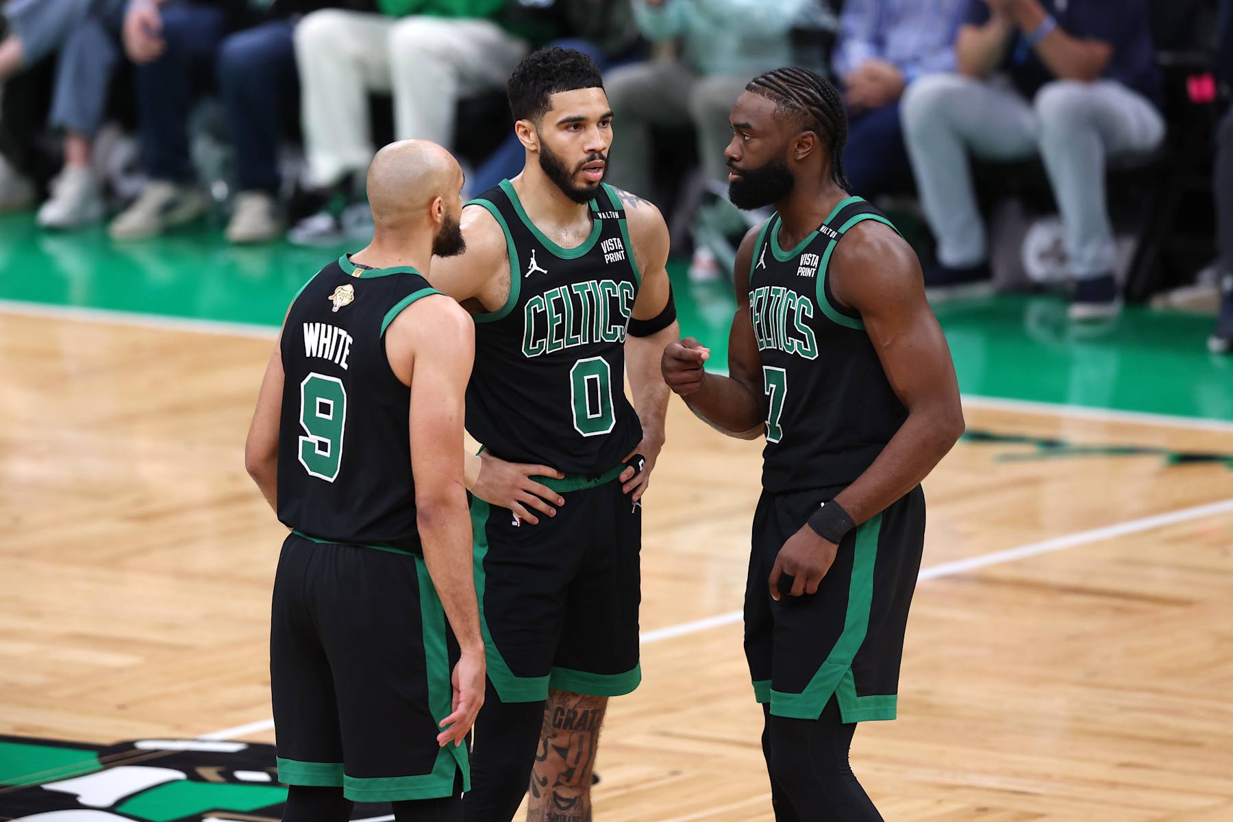 BOSTON, MASSACHUSETTS - JUNE 09: Derrick White #9, Jayson Tatum #0, and Jaylen Brown #7 of the Boston Celtics huddle during the first quarter against the Dallas Mavericks in Game Two of the 2024 NBA Finals at TD Garden on June 09, 2024 in Boston, Massachusetts. NOTE TO USER: User expressly acknowledges and agrees that, by downloading and or using this photograph, User is consenting to the terms and conditions of the Getty Images License Agreement. (Photo by Adam Glanzman/Getty Images)