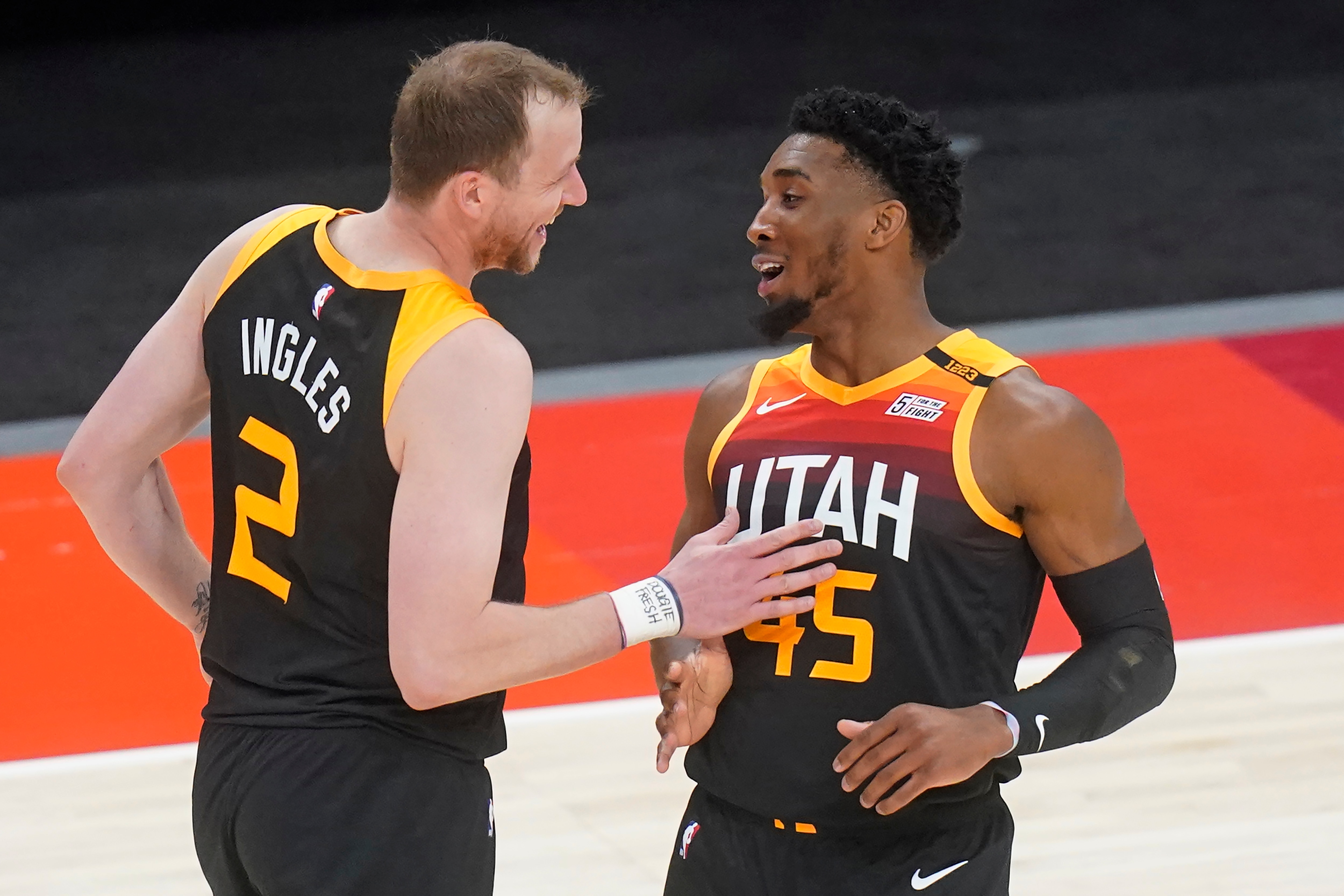 Utah Jazz's Donovan Mitchell (45) celebrates with Joe Ingles (2) after scoring a three-point basket against the Orlando Magic in the first half during an NBA basketball game Saturday, April 3, 2021, in Salt Lake City. (AP Photo/Rick Bowmer)