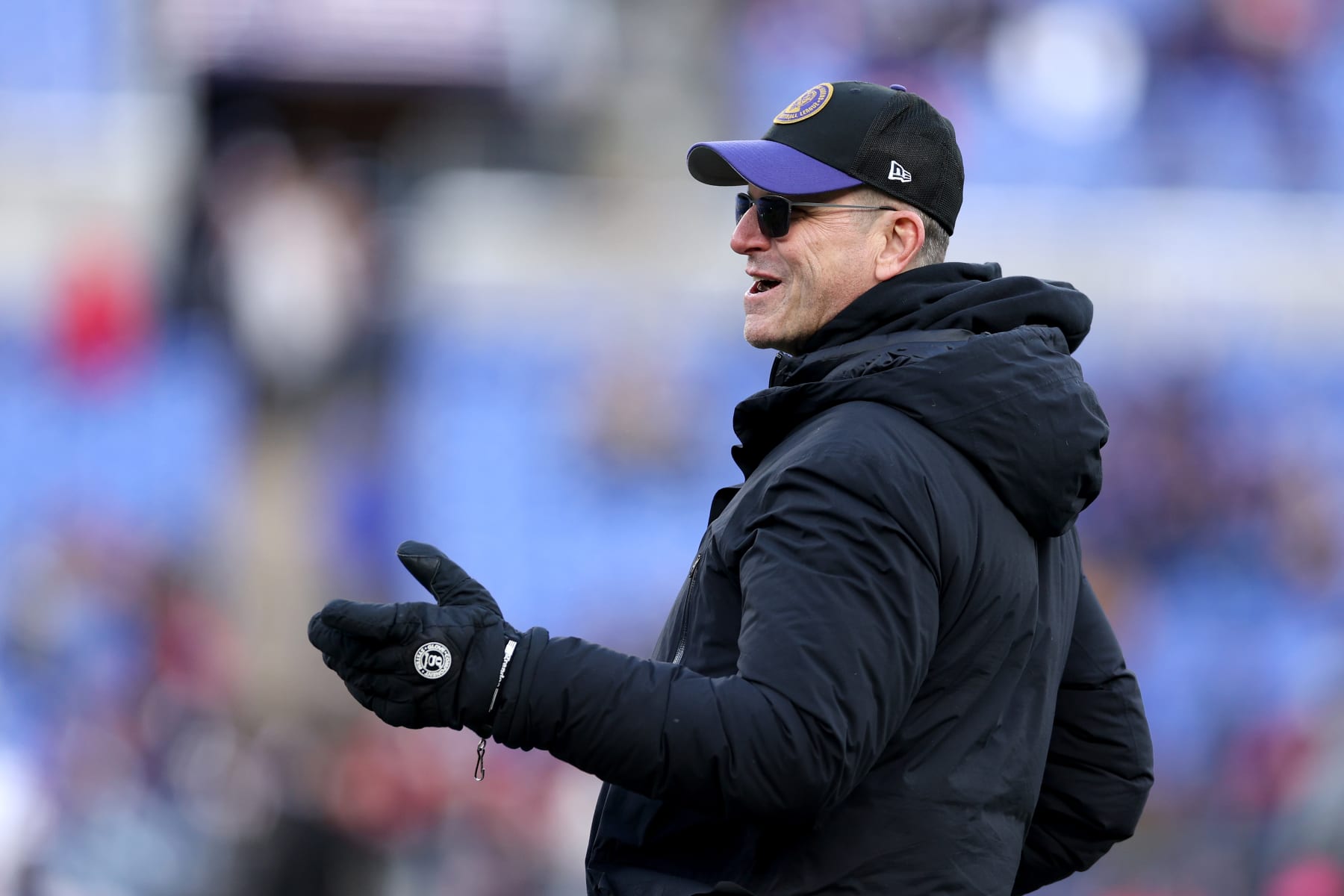 BALTIMORE, MARYLAND - JANUARY 20: Head coach Jim Harbaugh of the Michigan Wolverines looks on prior to the AFC Divisional Playoff game between the Baltimore Ravens and the Houston Texans at M&T Bank Stadium on January 20, 2024 in Baltimore, Maryland. Jim's brother, John is the Raven's head coach. (Photo by Patrick Smith/Getty Images)
