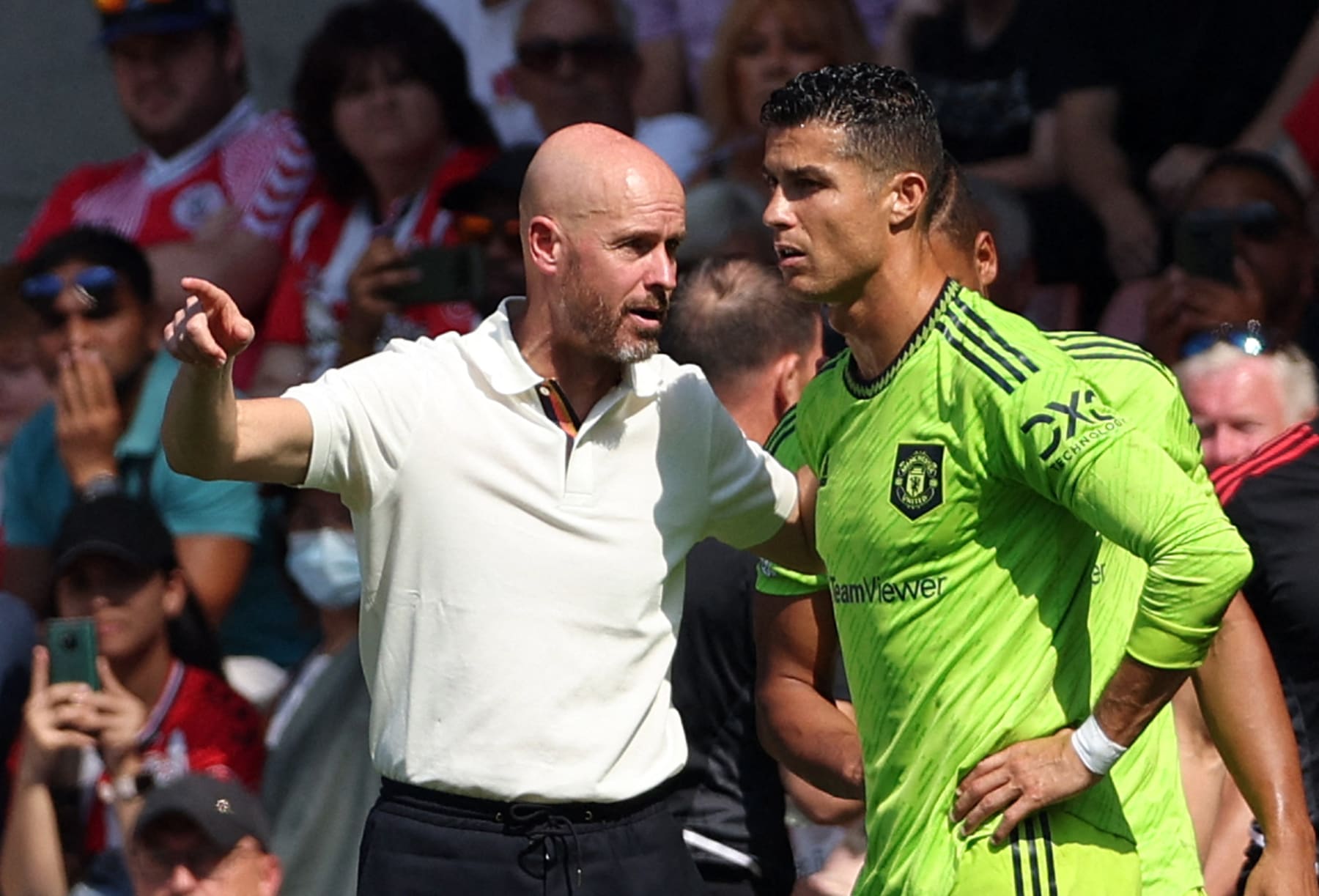 TOPSHOT - Manchester United's Dutch manager Erik ten Hag (L) directs substitute Manchester United's Portuguese striker Cristiano Ronaldo during the English Premier League football match between Southampton and Manchester United at St Mary's Stadium in Southampton, southern England on August 27, 2022. - RESTRICTED TO EDITORIAL USE. No use with unauthorized audio, video, data, fixture lists, club/league logos or 'live' services. Online in-match use limited to 120 images. An additional 40 images may be used in extra time. No video emulation. Social media in-match use limited to 120 images. An additional 40 images may be used in extra time. No use in betting publications, games or single club/league/player publications. (Photo by Adrian DENNIS / AFP) / RESTRICTED TO EDITORIAL USE. No use with unauthorized audio, video, data, fixture lists, club/league logos or 'live' services. Online in-match use limited to 120 images. An additional 40 images may be used in extra time. No video emulation. Social media in-match use limited to 120 images. An additional 40 images may be used in extra time. No use in betting publications, games or single club/league/player publications. / RESTRICTED TO EDITORIAL USE. No use with unauthorized audio, video, data, fixture lists, club/league logos or 'live' services. Online in-match use limited to 120 images. An additional 40 images may be used in extra time. No video emulation. Social media in-match use limited to 120 images. An additional 40 images may be used in extra time. No use in betting publications, games or single club/league/player publications. (Photo by ADRIAN DENNIS/AFP via Getty Images)