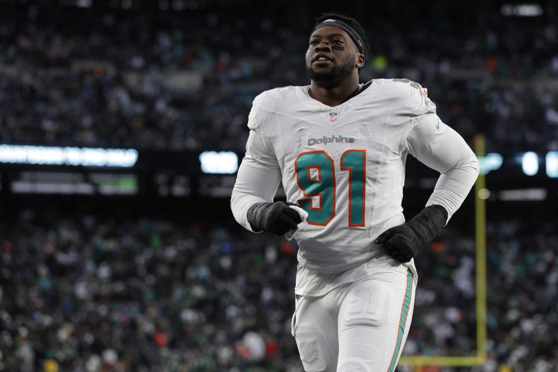 EAST RUTHERFORD, NEW JERSEY - NOVEMBER 24: Defensive end Emmanuel Ogbah #91 of the Miami Dolphins walks off the field at the end of the first half of a football game against the New York Jets at MetLife Stadium on November 24, 2023 in East Rutherford, New Jersey. (Photo by Rich Schultz/Getty Images)