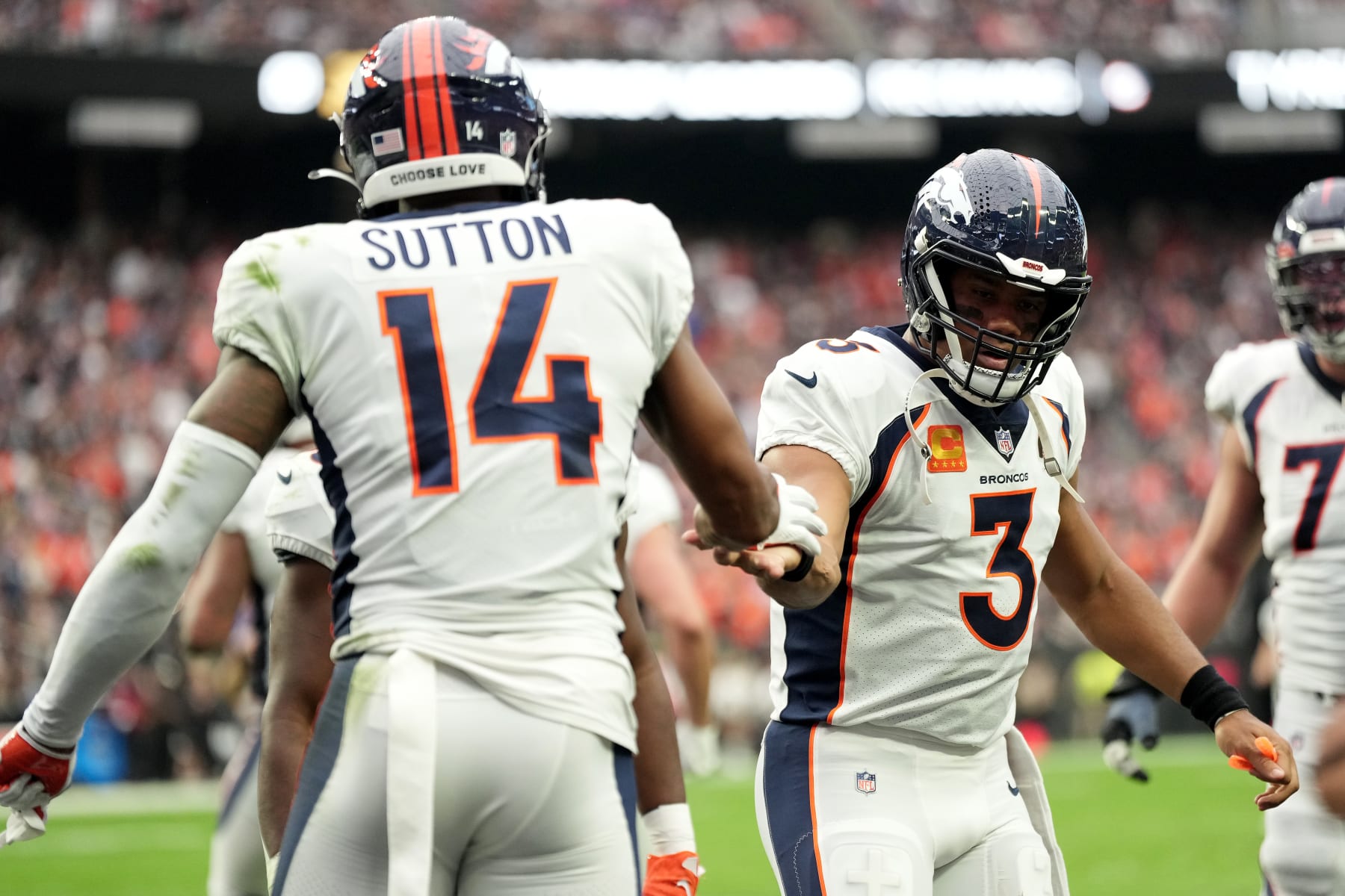 LAS VEGAS, NEVADA - OCTOBER 02: Courtland Sutton #14 and Russell Wilson #3 of the Denver Broncos celebrate after scoring a touchdown in the first quarter against the Las Vegas Raiders at Allegiant Stadium on October 02, 2022 in Las Vegas, Nevada. (Photo by Jeff Bottari/Getty Images)
