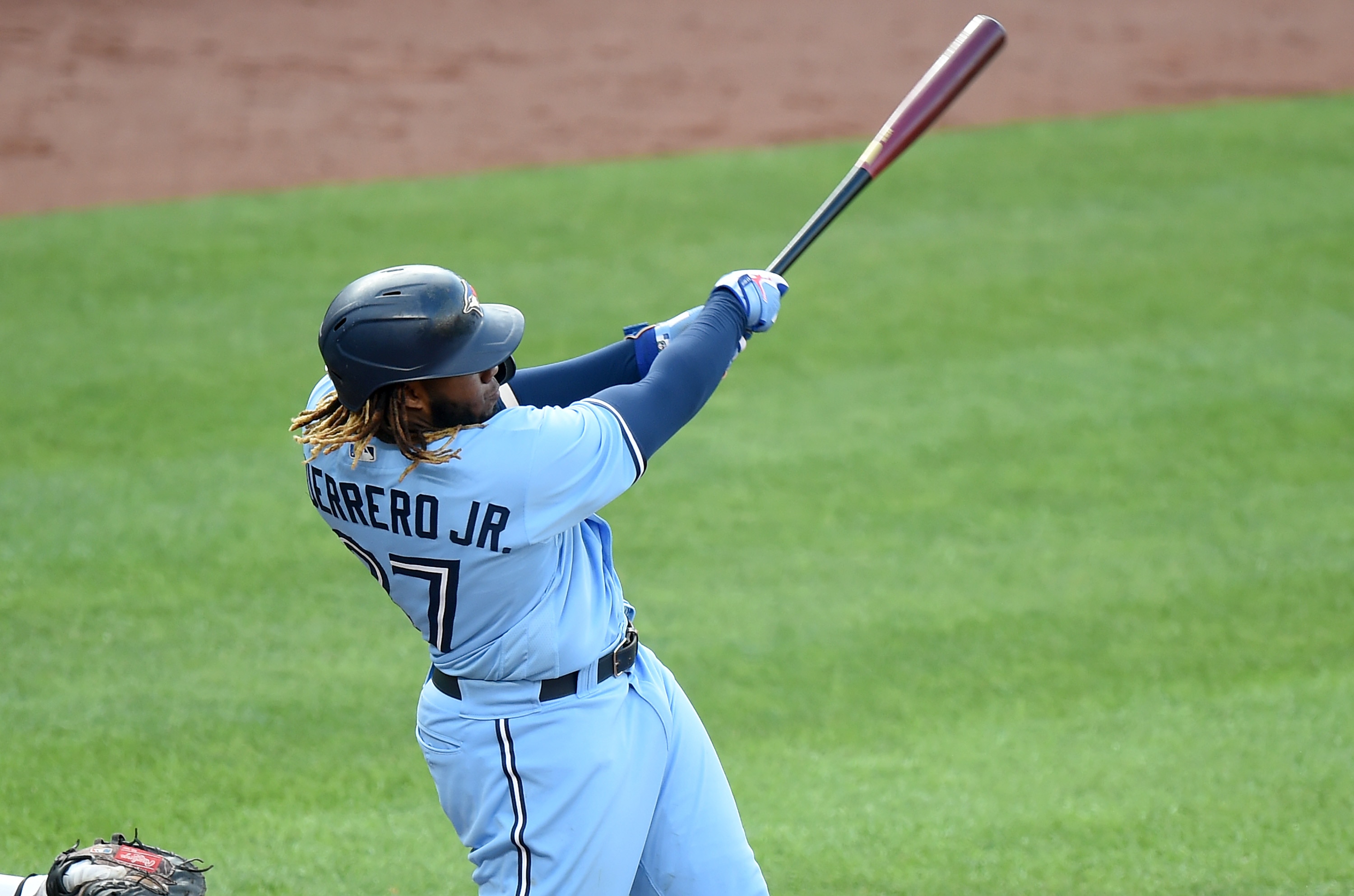 BALTIMORE, MARYLAND - JUNE 19: Vladimir Guerrero Jr. #27 of the Toronto Blue Jays drives in the game-winning run with a double in the ninth inning against the Baltimore Orioles at Oriole Park at Camden Yards on June 19, 2021 in Baltimore, Maryland. (Photo by Greg Fiume/Getty Images)