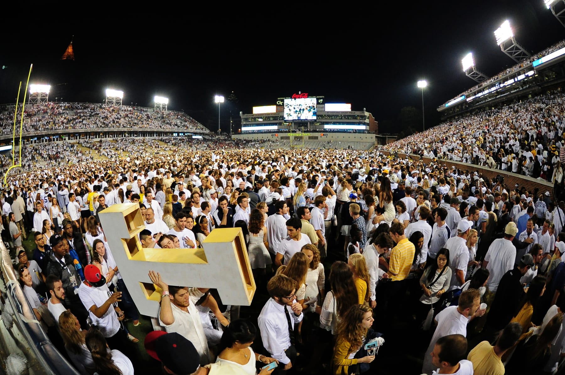  Fans of the Georgia Tech Yellow Jackets cover the field at Bobby Dodd Stadium after defeating the Florida State Seminoles