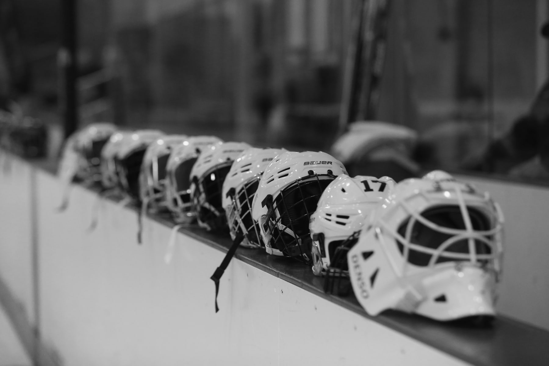 BROOKLYN, NY - OCTOBER 25:  (EDITORS NOTE: Image has been converted to black and white.) helmets belonging to the New York Riveters of the National Womens Hockey League are placed on the boards prior to the game against the Connecticut Whale at the Aviator Sports and Event Center on October 25, 2015 in Brooklyn borough of New York City.  (Photo by Bruce Bennett/Getty Images)
