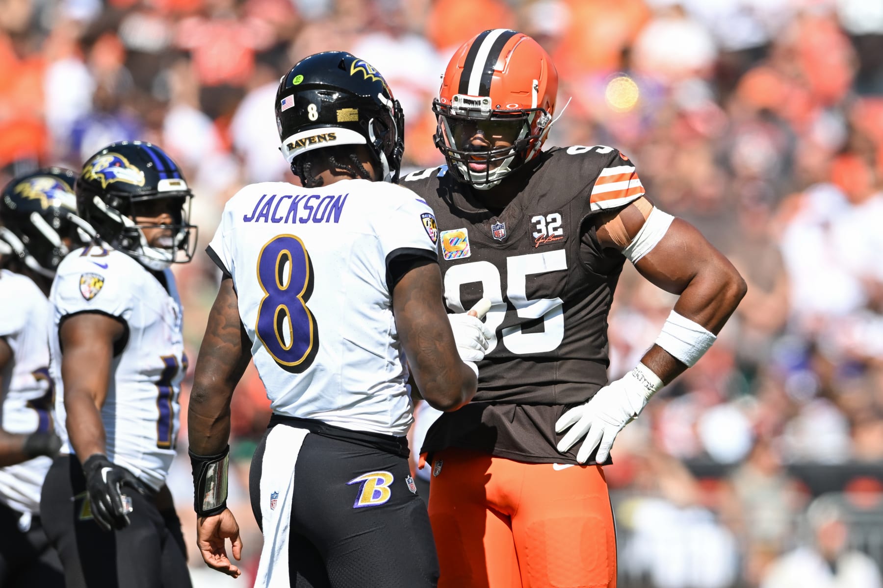 CLEVELAND, OHIO - OCTOBER 01: Myles Garrett #95 of the Cleveland Browns talks with Lamar Jackson #8 of the Baltimore Ravens during the first half at Cleveland Browns Stadium on October 01, 2023 in Cleveland, Ohio. (Photo by Nick Cammett/Diamond Images via Getty Images)