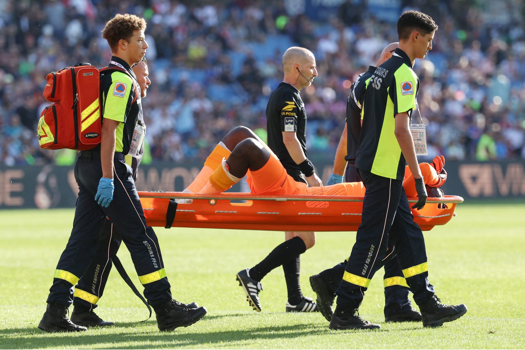 Clermont-Ferrand's French goalkeeper #99 Mory Diaw injured by a firecracker, is evacuated on a stretcher  during the French L1 football match between Montpellier Herault SC and Clermont Foot 63  at Stade de la Mosson in Montpellier, southern France on October 8, 2023. (Photo by Pascal GUYOT / AFP) (Photo by PASCAL GUYOT/AFP via Getty Images)