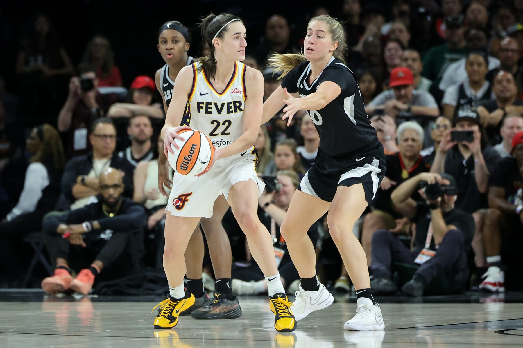 LAS VEGAS, NEVADA - MAY 25: Caitlin Clark #22 of the Indiana Fever looks to pass against Kate Martin #20 of the Las Vegas Aces during the third quarter in the game at Michelob ULTRA Arena on May 25, 2024 in Las Vegas, Nevada. NOTE TO USER: User expressly acknowledges and agrees that, by downloading and or using this photograph, User is consenting to the terms and conditions of the Getty Images License Agreement. (Photo by Ethan Miller/Getty Images)