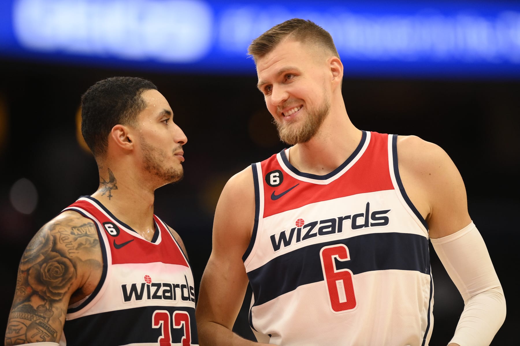 Washington Wizards center Kristaps Porzingis (6) and forward Kyle Kuzma (33) talk during the second half of an NBA basketball game against the Detroit Pistons, Tuesday, Oct. 25, 2022, in Washington. The Wizards won 120–99. (AP Photo/Nick Wass)