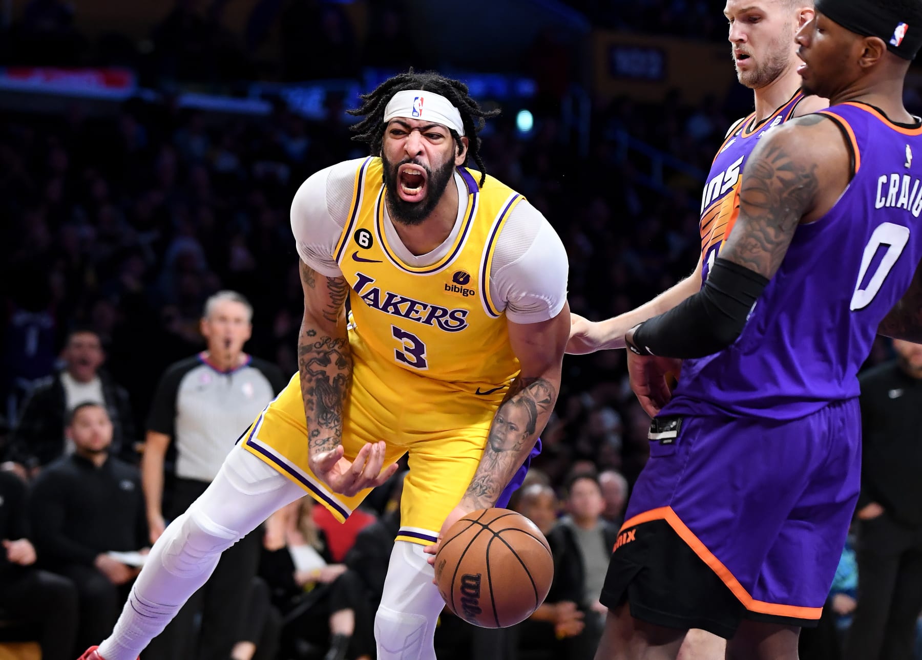 Los Angeles, California March 22, 2023-Lakers Anthony Davis celebrates his his dunk in front of Suns Torrey Craig (0) and Jack Landale in the third quarter at Crypto.com arena Wednesday. (Wally Skalij/Los Angeles Times via Getty Images)