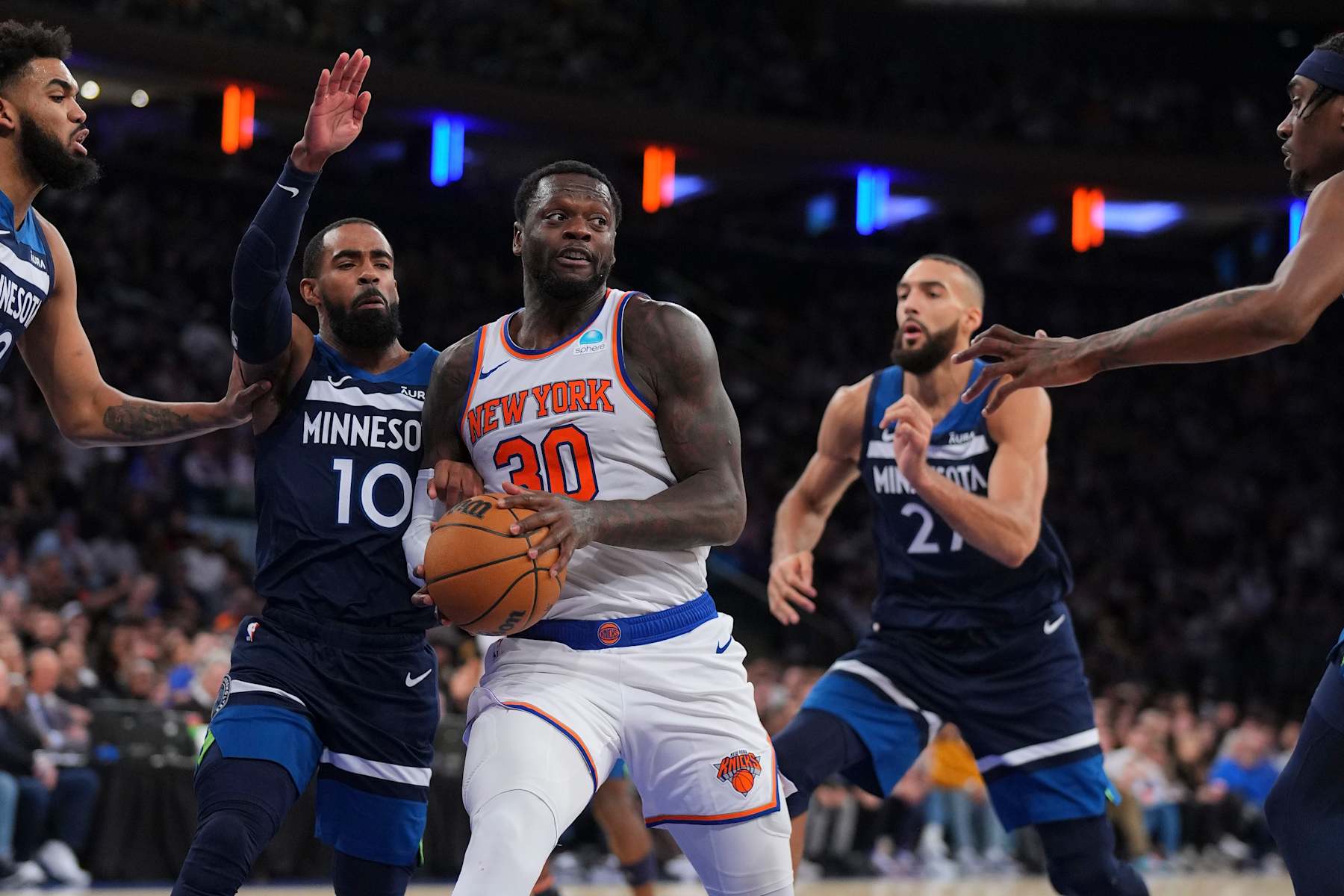 NEW YORK, NEW YORK - JANUARY 1: Julius Randle #30 of the New York Knicks controls the ball against Mike Conley #10 and Rudy Gobert #27 of the Minnesota Timberwolves at Madison Square Garden on January 1, 2024 in New York City. The Knicks defeated the Timberwolves 112-106. NOTE TO USER: User expressly acknowledges and agrees that, by downloading and or using this photograph, User is consenting to the terms and conditions of the Getty Images License Agreement. (Photo by Mitchell Leff/Getty Images)