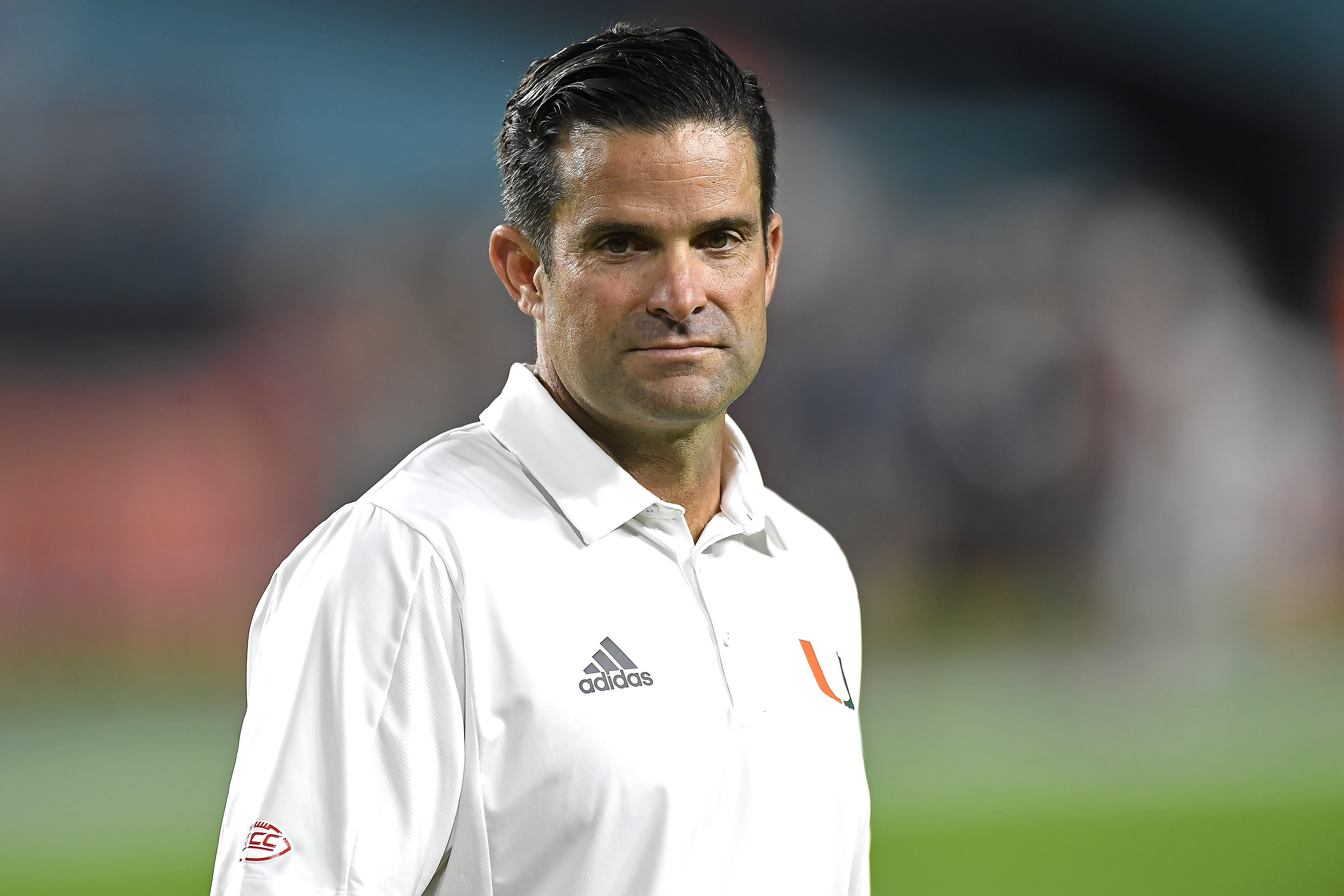 MIAMI GARDENS, FL - NOVEMBER 20:  Miami head coach Manny Diaz watches as his players warm up prior to the game as the University of Miami Hurricanes faced the Virginia Tech Hokies on November 20, 2021, at Hard Rock Stadium in Miami Gardens, Florida. (Photo by Samuel Lewis/Icon Sportswire via Getty Images)