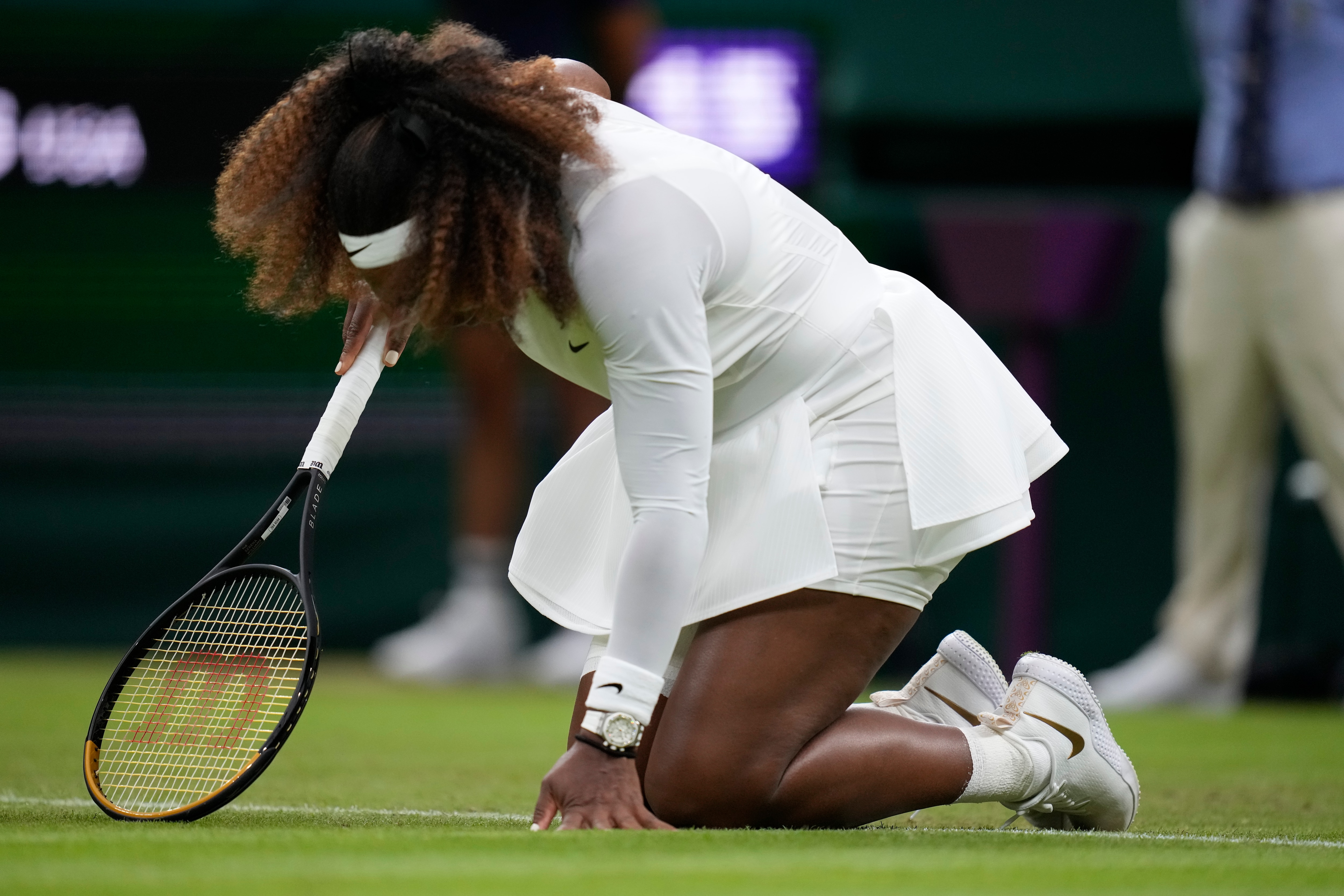Serena Williams of the US falls to the ground during the women's singles first round match against Aliaksandra Sasnovich of Belarus on day two of the Wimbledon Tennis Championships in London, Tuesday June 29, 2021. (AP Photo/Kirsty Wigglesworth)