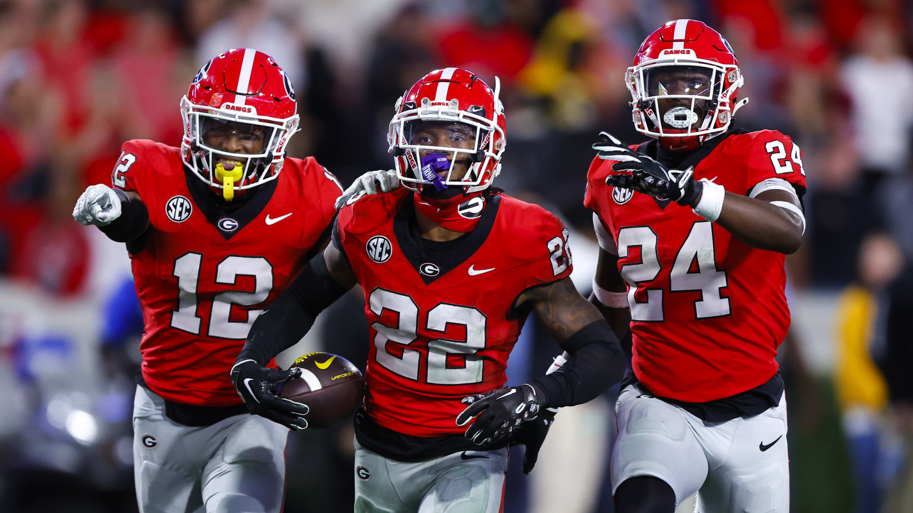 ATHENS, GEORGIA - NOVEMBER 4: Javon Bullard #22 of the Georgia Bulldogs reacts after his interception with Julian Humphrey #12 and Malaki Starks #24 during the fourth quarter against the Missouri Tigers at Sanford Stadium on November 4, 2023 in Athens, Georgia. (Photo by Todd Kirkland/Getty Images)