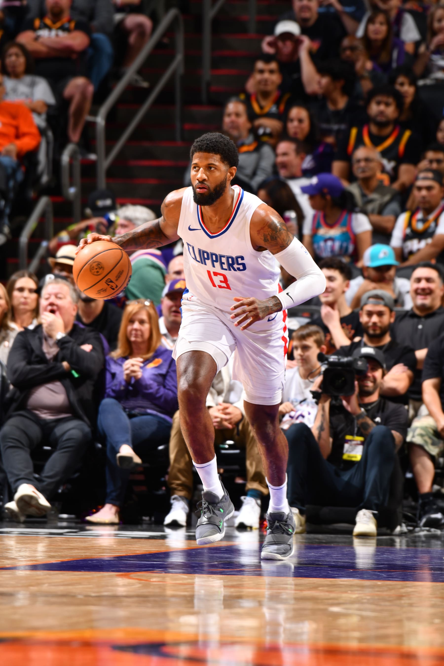 PHOENIX, AZ - APRIL 9:  Paul George #13 of the LA Clippers handles the ball during the game  on April 9, 2024 at Footprint Center in Phoenix, Arizona. NOTE TO USER: User expressly acknowledges and agrees that, by downloading and or using this photograph, user is consenting to the terms and conditions of the Getty Images License Agreement. Mandatory Copyright Notice: Copyright 2024 NBAE (Photo by Barry Gossage/NBAE via Getty Images)