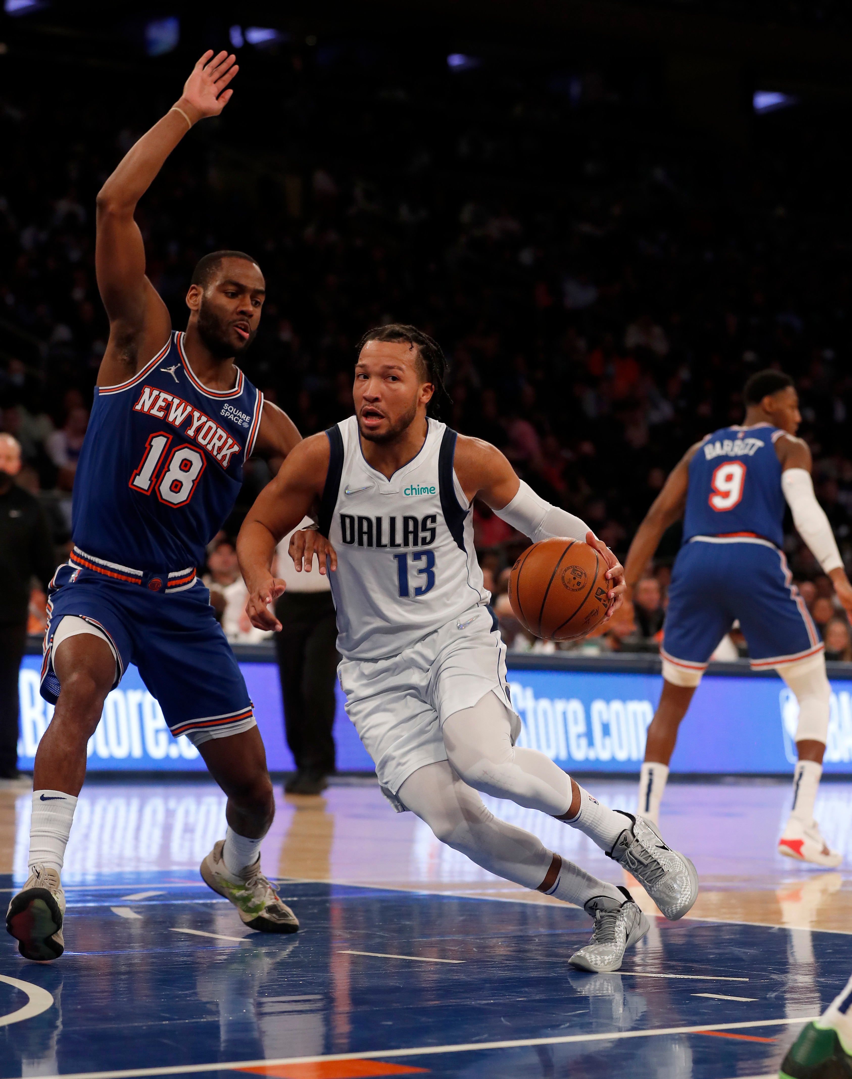NEW YORK, NEW YORK - JANUARY 12: (NEW YORK DAILIES OUT)  Jalen Brunson #13 of the Dallas Mavericks in action against Alec Burks #18 of the New York Knicks at Madison Square Garden on January 12, 2022 in New York City. The Knicks defeated the Mavericks 108-85. NOTE TO USER: User expressly acknowledges and agrees that, by downloading and or using this photograph, user is consenting to the terms and conditions of the Getty Images License Agreement. (Photo by Jim McIsaac/Getty Images)