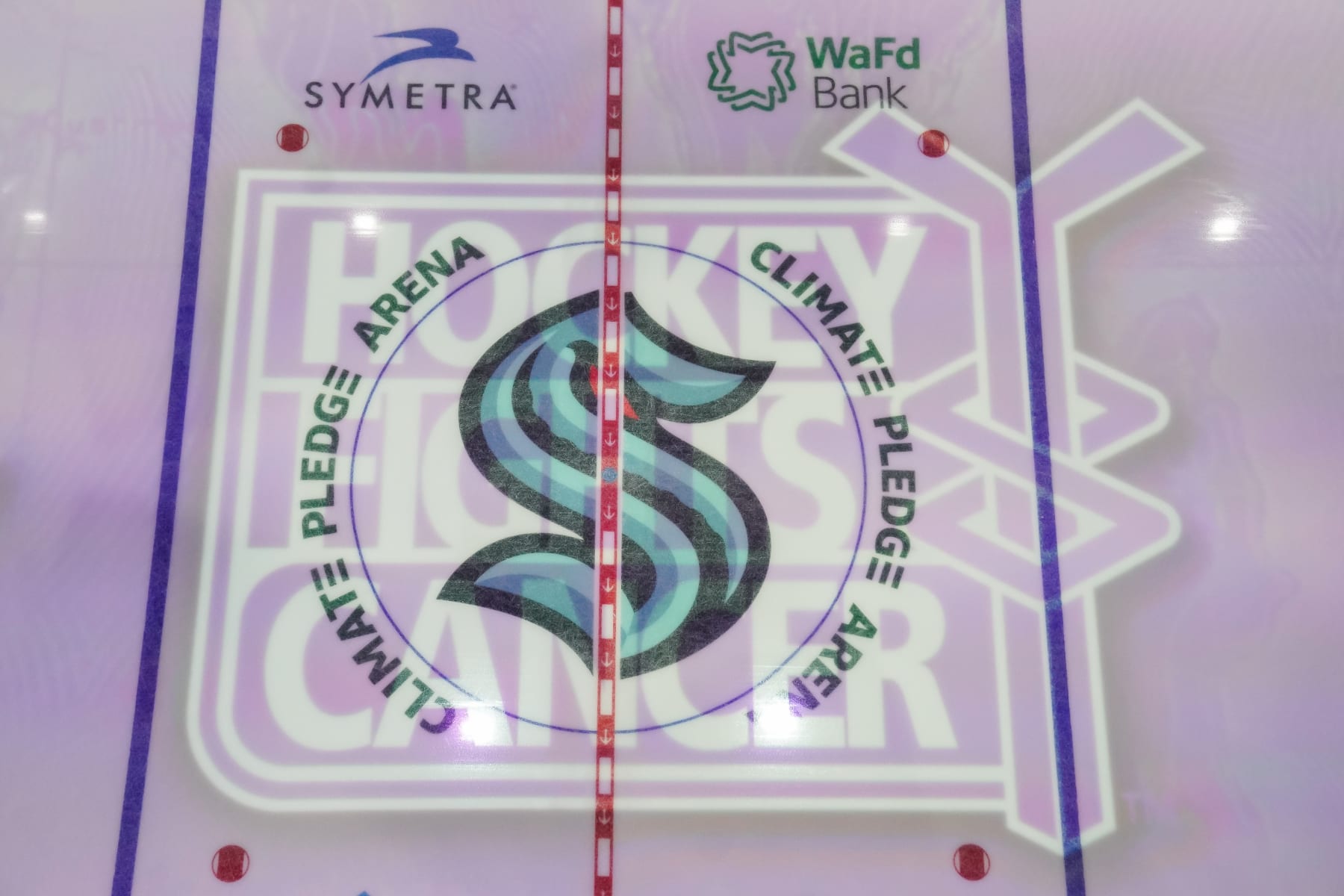SEATTLE, WASHINGTON - NOVEMBER 21: The Hockey Fights Cancer logo is projected on the ice prior to a game between the Washington Capitals and the Seattle Kraken at Climate Pledge Arena on November 21, 2021 in Seattle, Washington. (Photo by Christopher Mast/NHLI via Getty Images)