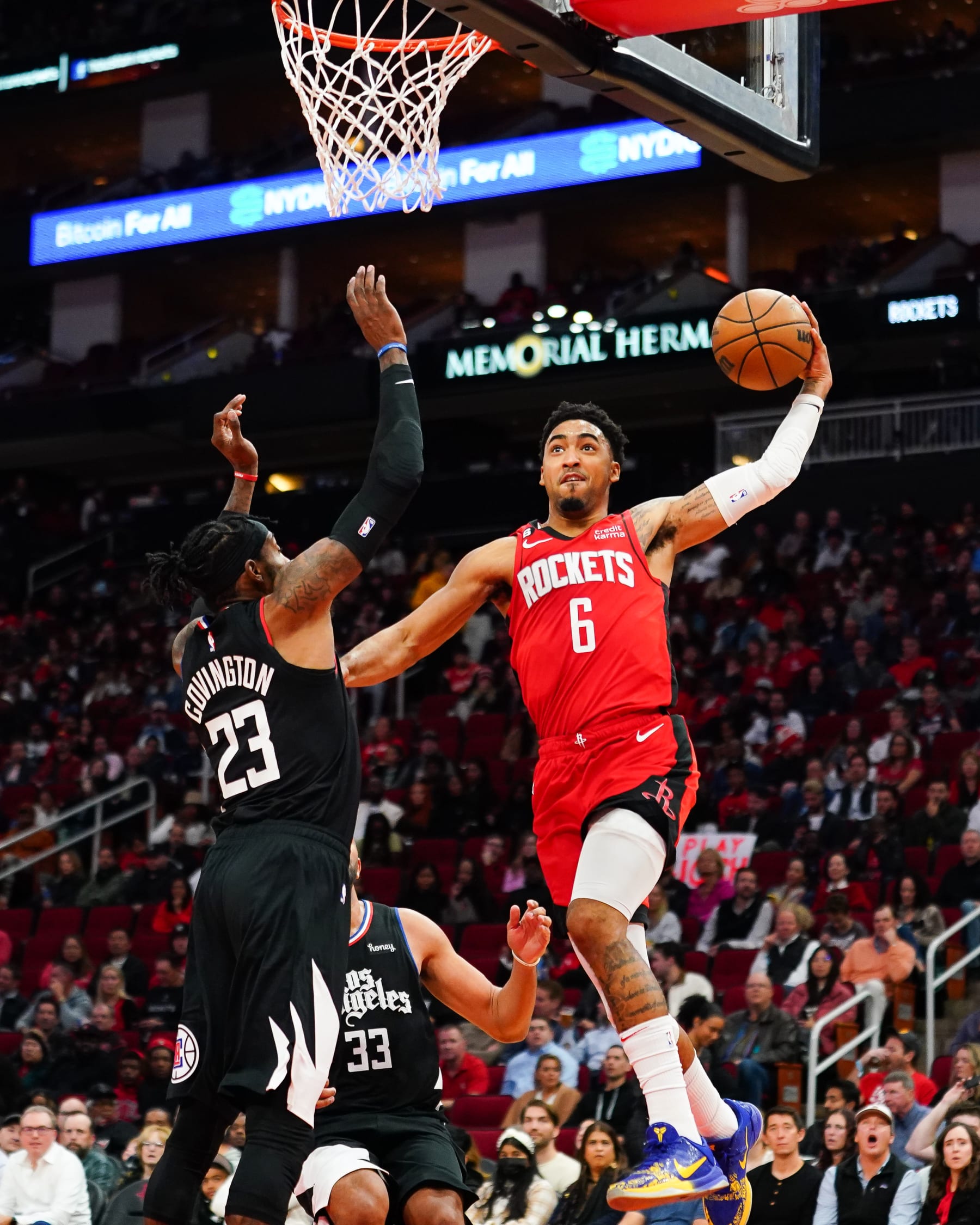 HOUSTON, TEXAS - NOVEMBER 14: Kenyon Martin Jr. #6 of the Houston Rockets dunks over Robert Covington #23 of the LA Clippers during the fourth quarter of the game at the Toyota Center on November 14, 2022 in Houston, Texas. NOTE TO USER: User expressly acknowledges and agrees that, by downloading and or using this photograph, User is consenting to the terms and conditions of the Getty Images License Agreement. (Photo by Alex Bierens de Haan/Getty Images)