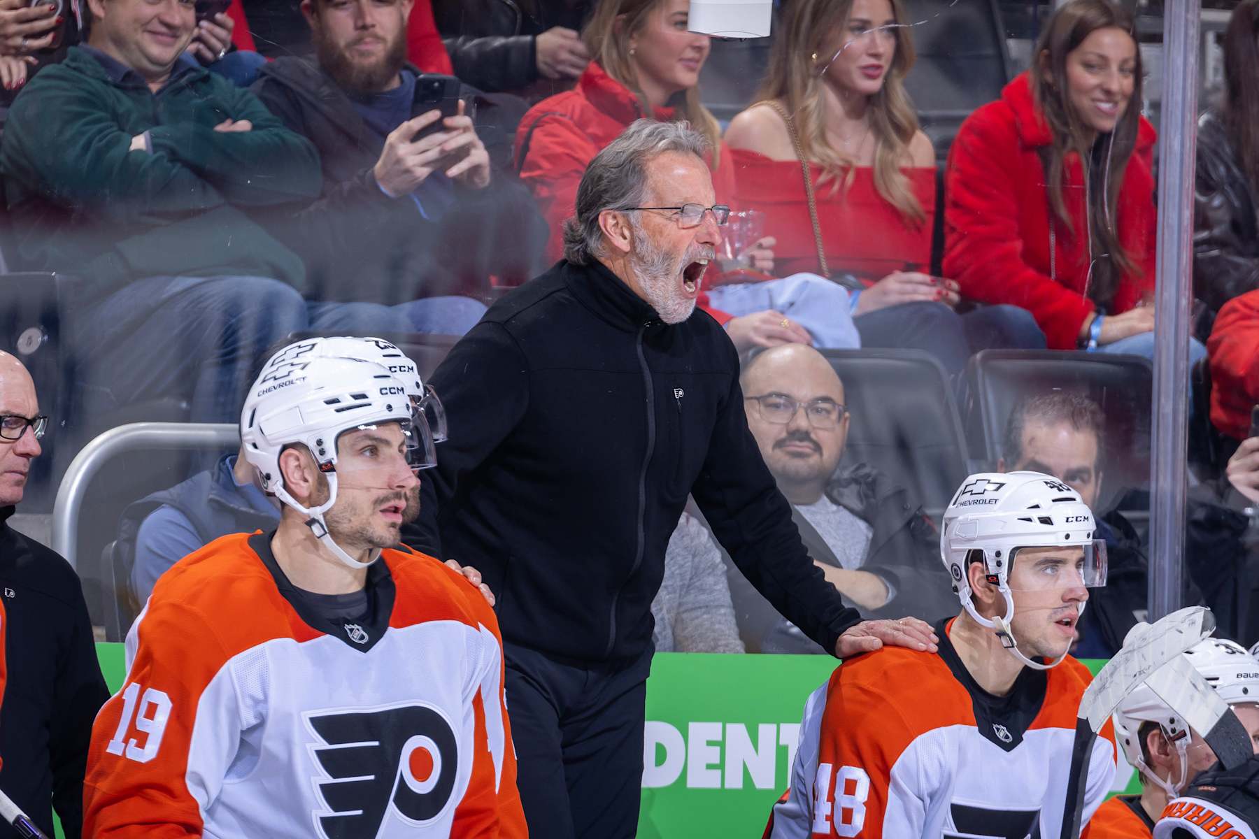 DETROIT, MICHIGAN - DECEMBER 18: Head coach John Tortorella of the Philadelphia Flyers doesn't like a call and yells at the referee during the third period of the game against the Detroit Red Wings at Little Caesars Arena on December 18, 2024 in Detroit, Michigan. Detroit defeated Philadelphia 6-4. (Photo by Dave Reginek/NHLI via Getty Images)